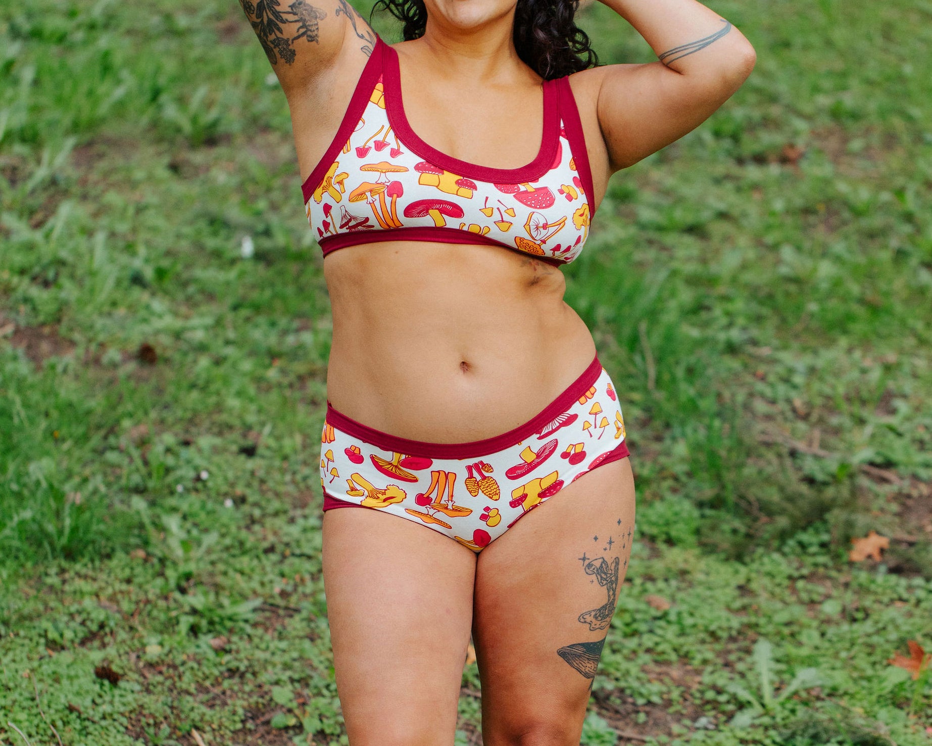 Model wearing Thunderpants Hipster style underwear and Bralette in Whadda Mushroom - red, yellow, and orange mushrooms.