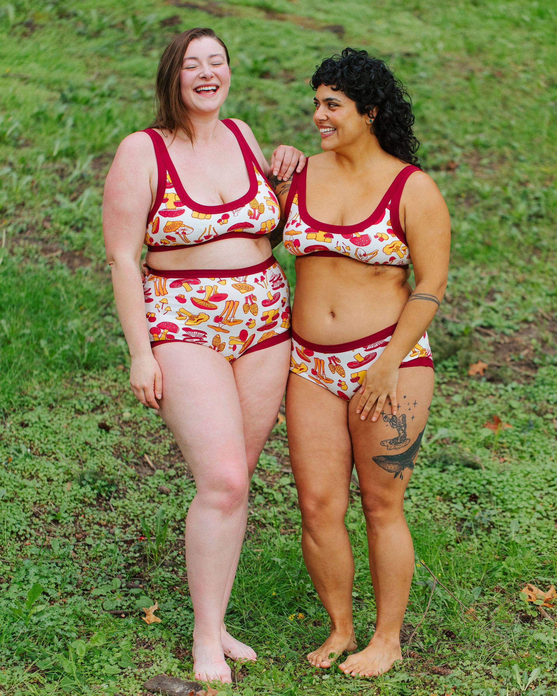 Two models wearing various Thunderpants styles in Whadda Mushroom - red, yellow, and orange mushrooms.