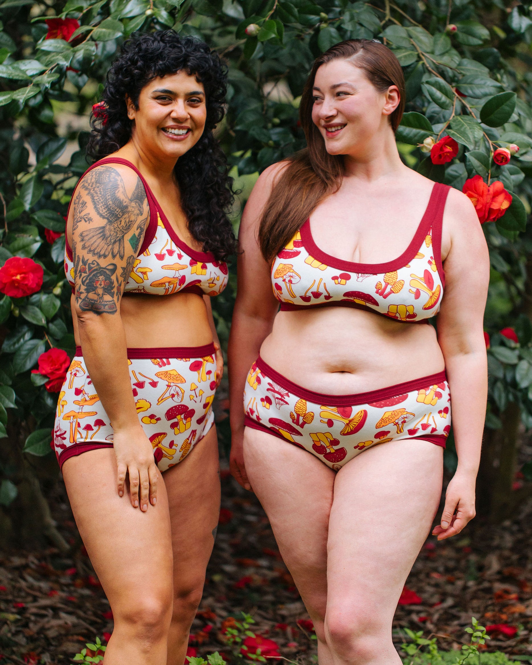 Two models wearing various Thunderpants styles in Whadda Mushroom - red, yellow, and orange mushrooms.
