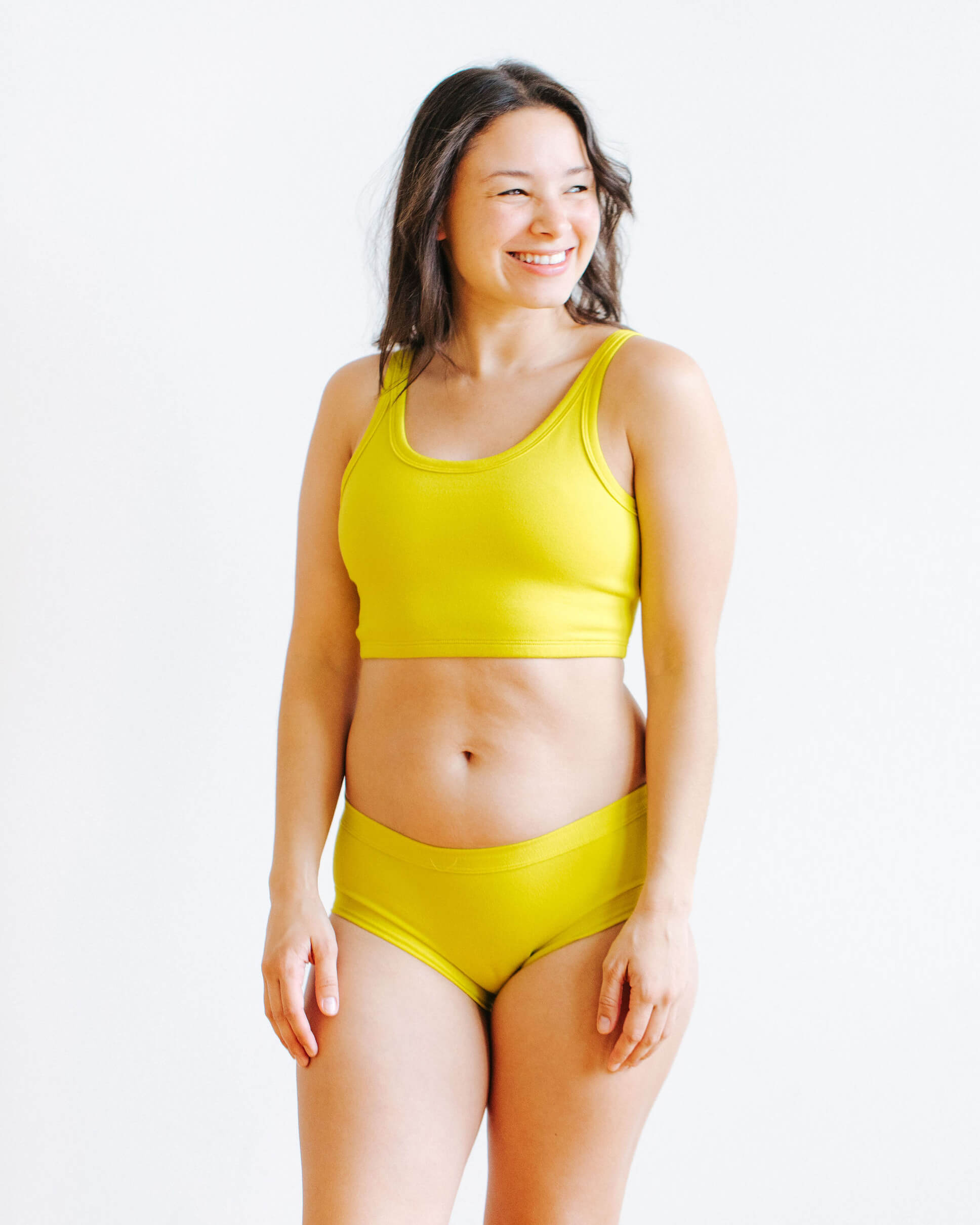 Model wearing Thunderpants Hipster style underwear and Longline Bra in Star Fruit color - a chartreuse yellow.