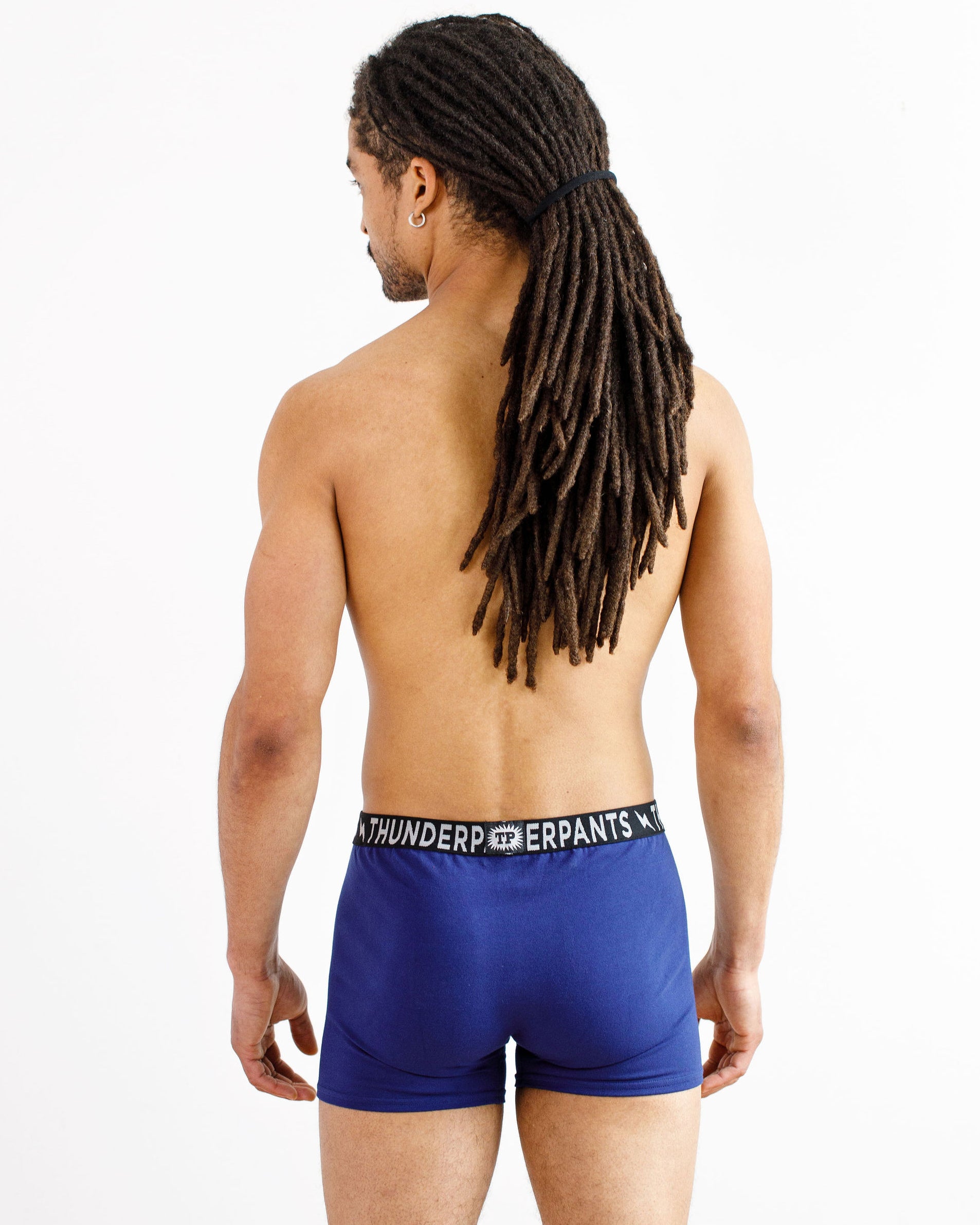 Male model wearing Thunderpants organic cotton Boxer Brief style underwear in Indigo.
