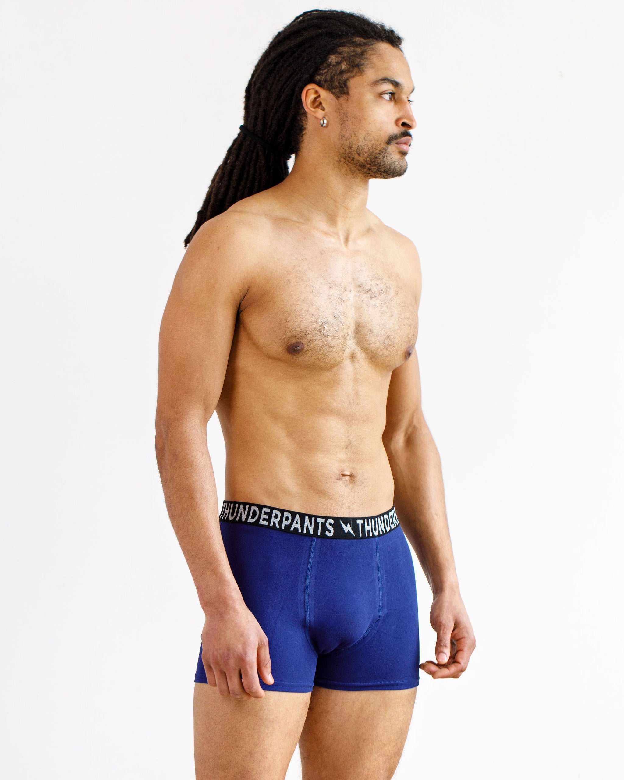 Male model wearing Thunderpants organic cotton Boxer Brief style underwear in Indigo.