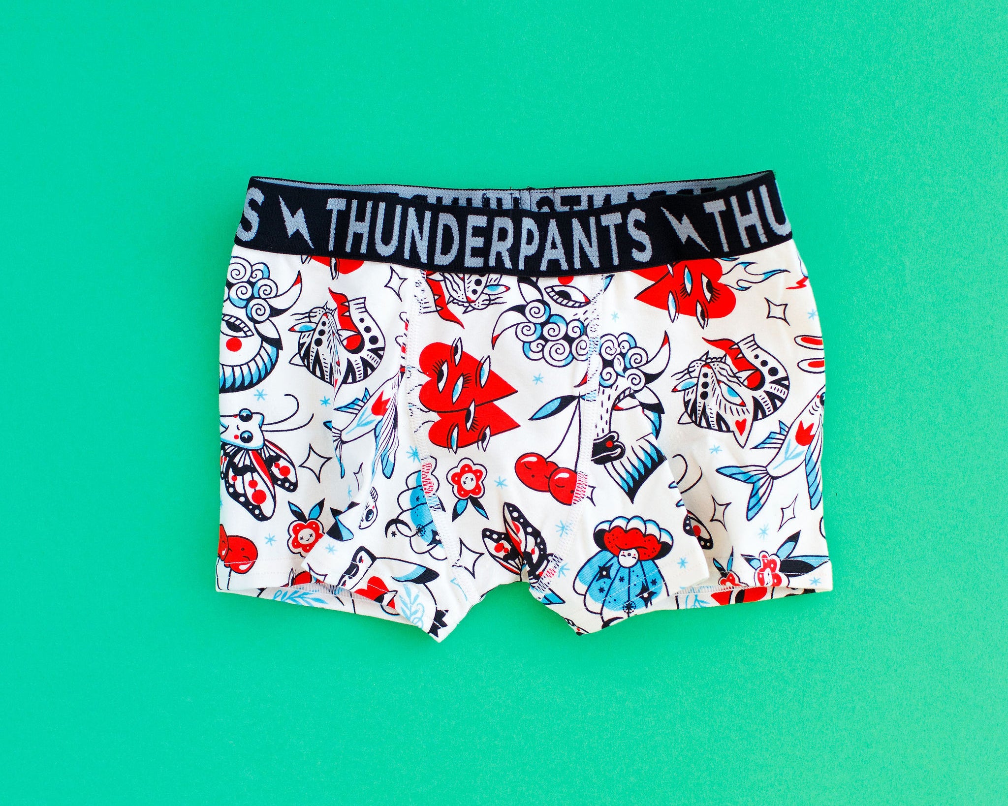 Flat lay of Kids Boxer Brief style underwear in Inked Up - red, blue, and black tattoos.
