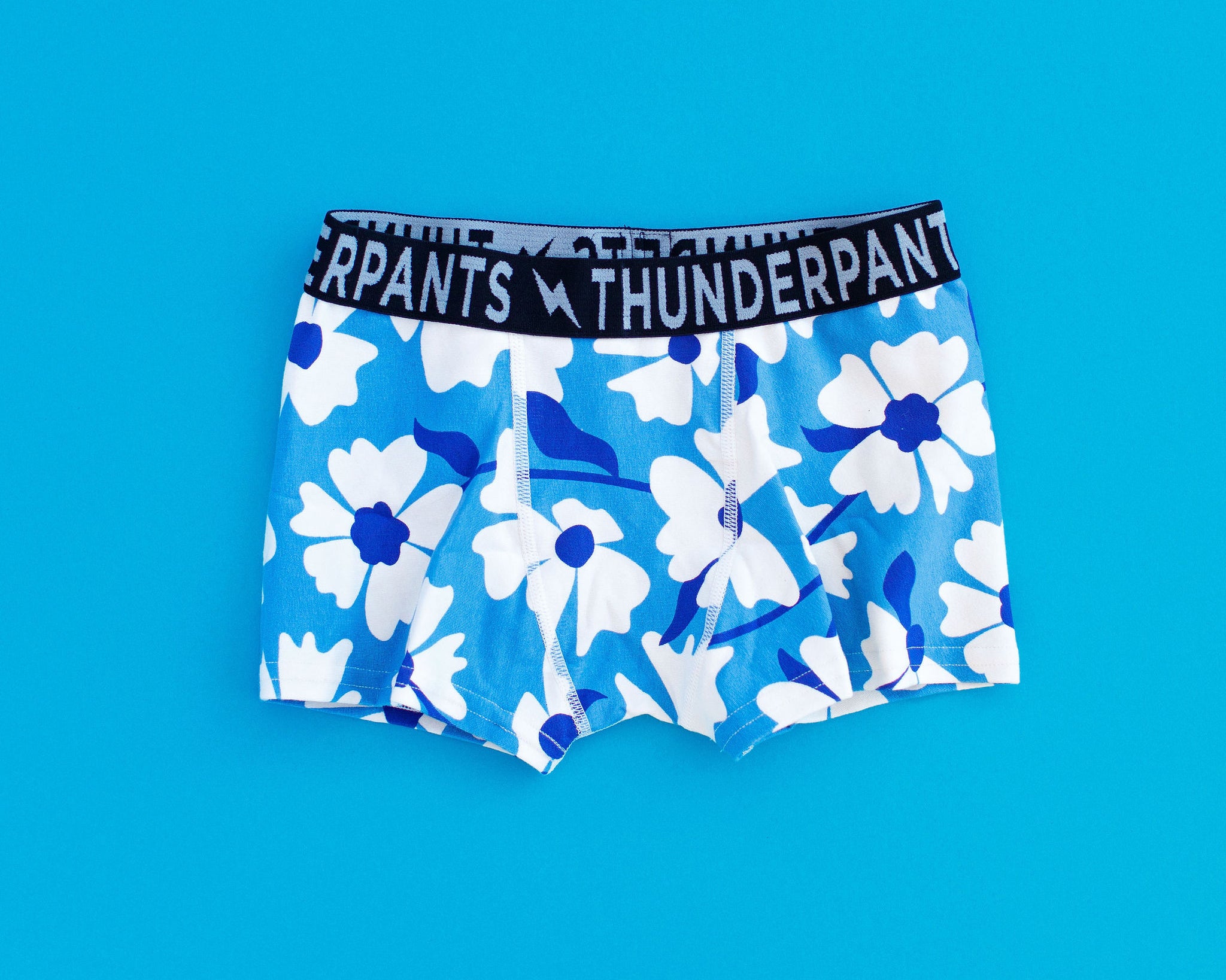 Flat lay of Kids Boxer Brief style underwear in Moody Blues - blue and white flowers.