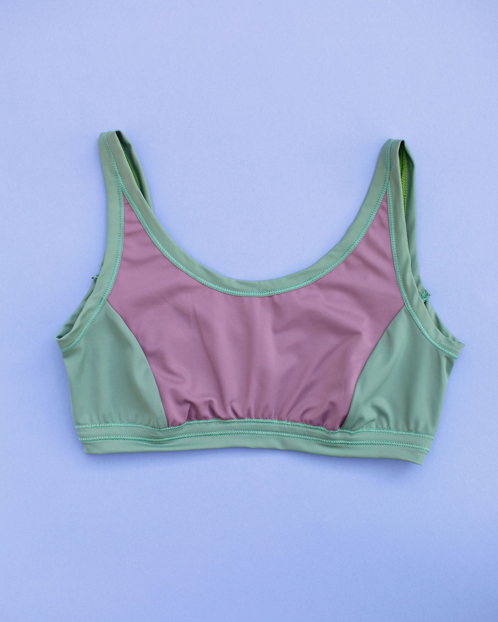 Flat lay of Thunderpants Swim Panel Top in lavender and lichen green.