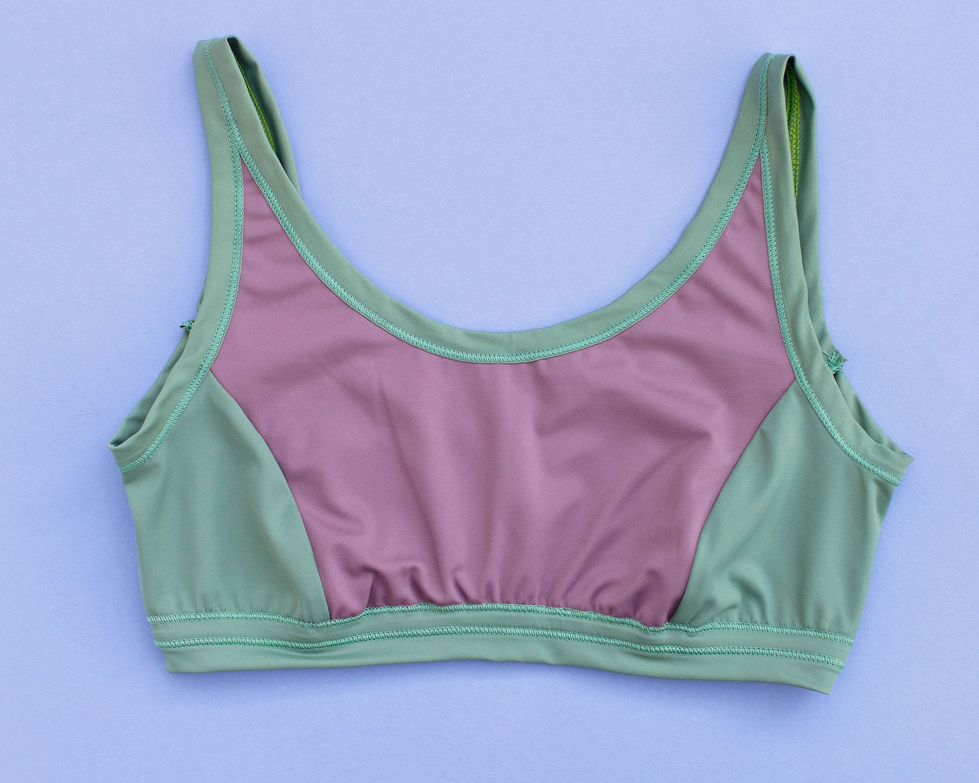 Flat lay of Thunderpants Swim Panel Top in lavender and lichen green.