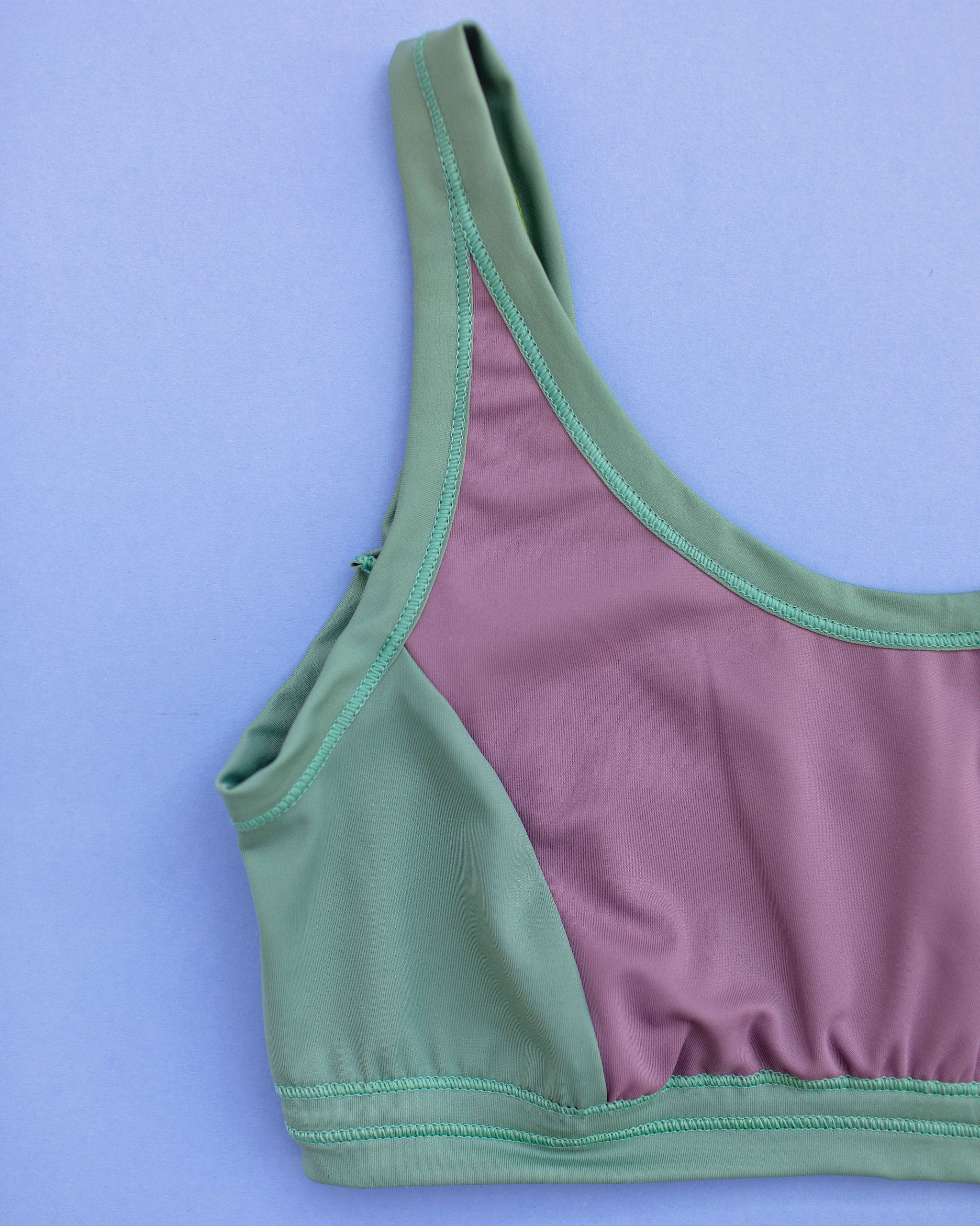 Flat lay of Thunderpants Swim Panel Top in lavender and lichen green.