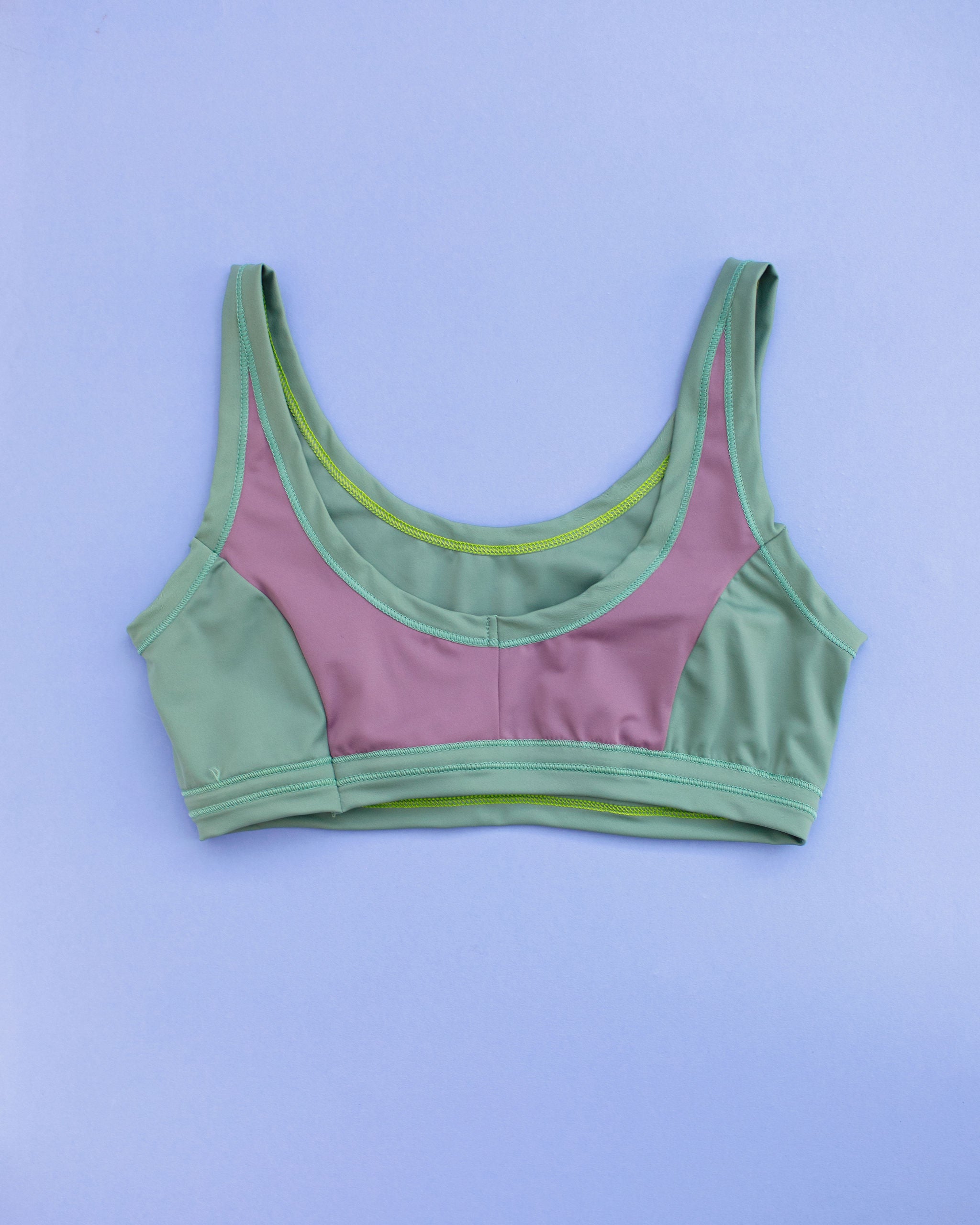 Flat lay of Thunderpants Swim Panel Top in lavender and lichen green.