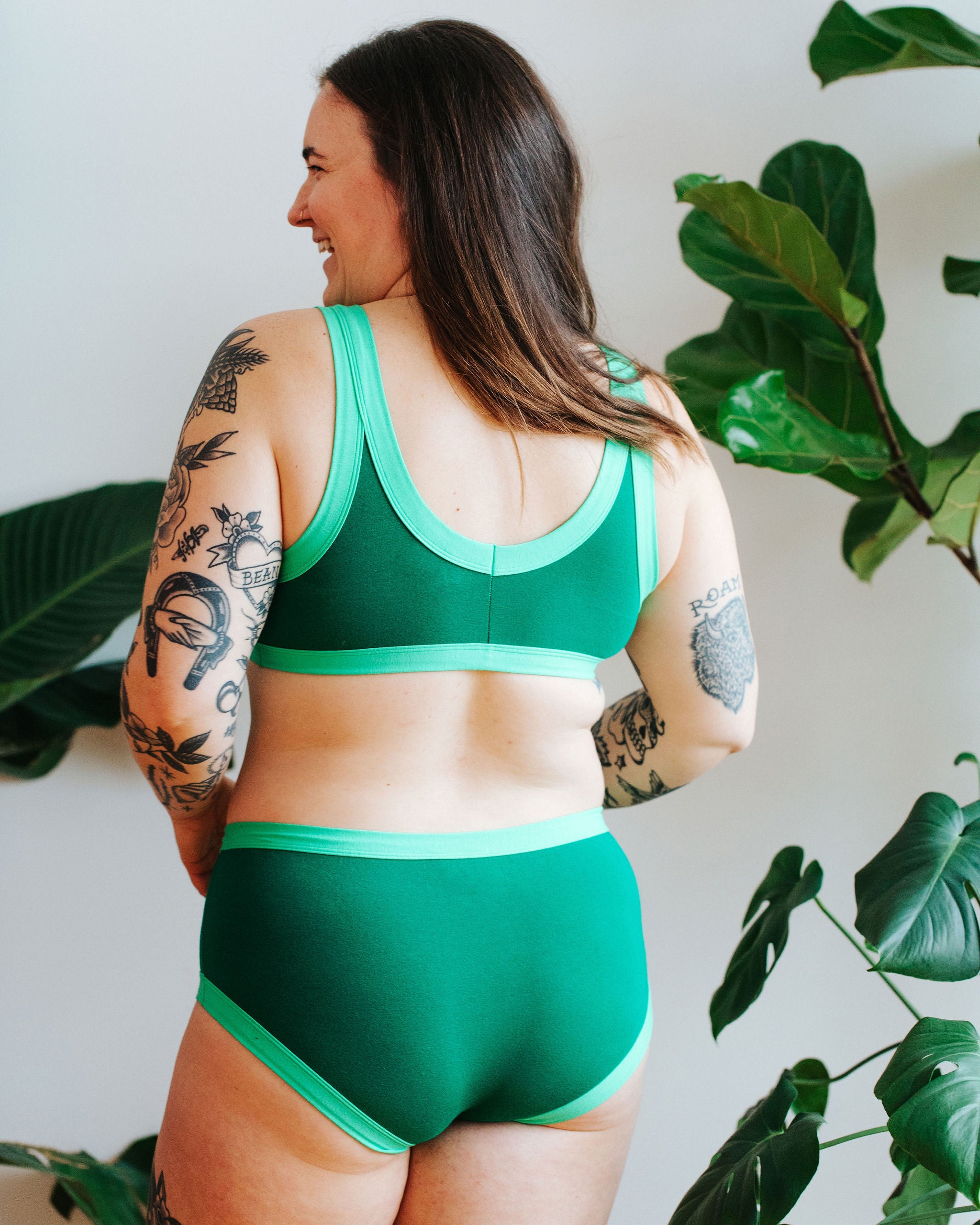 Model with their back to us wearing a Bralette in Lime Squeeze: Emerald Green with Sour Apple binding.