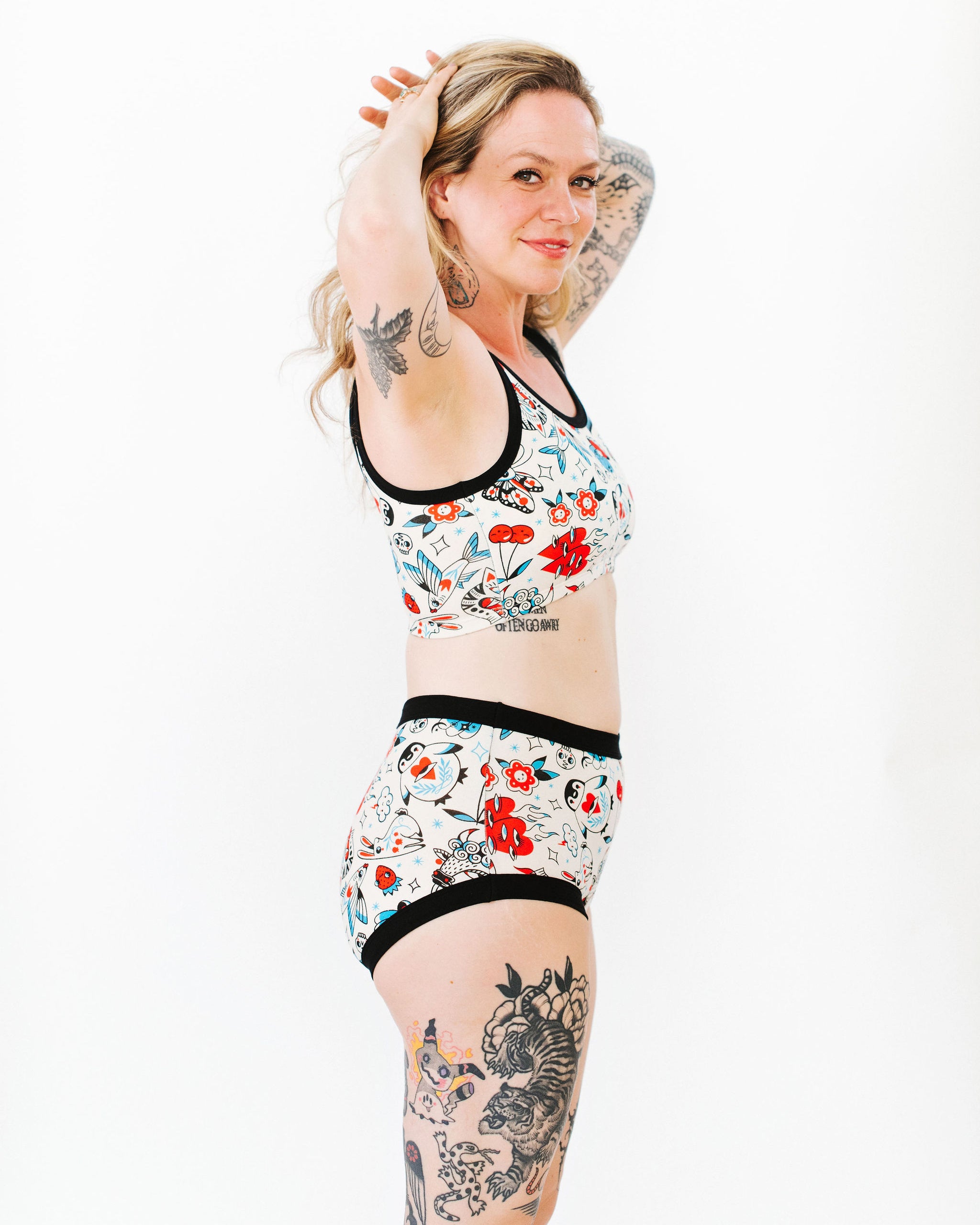 Model wearing Thunderpants Longline Bra and Original style underwear in Inked Up - a tattoo pattern with black, red, and blue. 