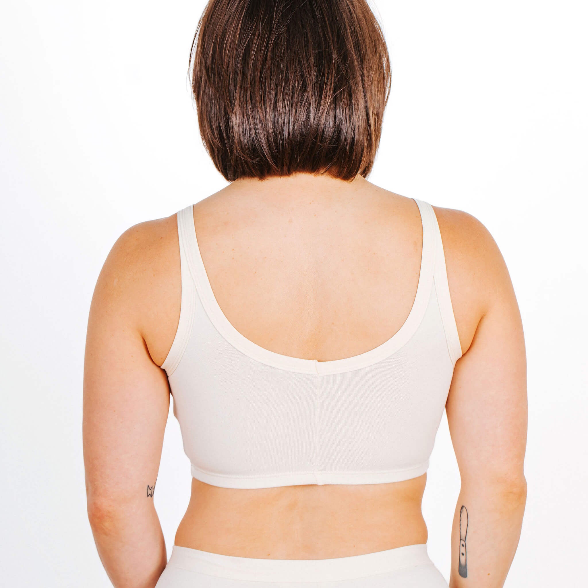 Fit photo from the back of Thunderpants organic cotton Longline Bra in off-white on a model.