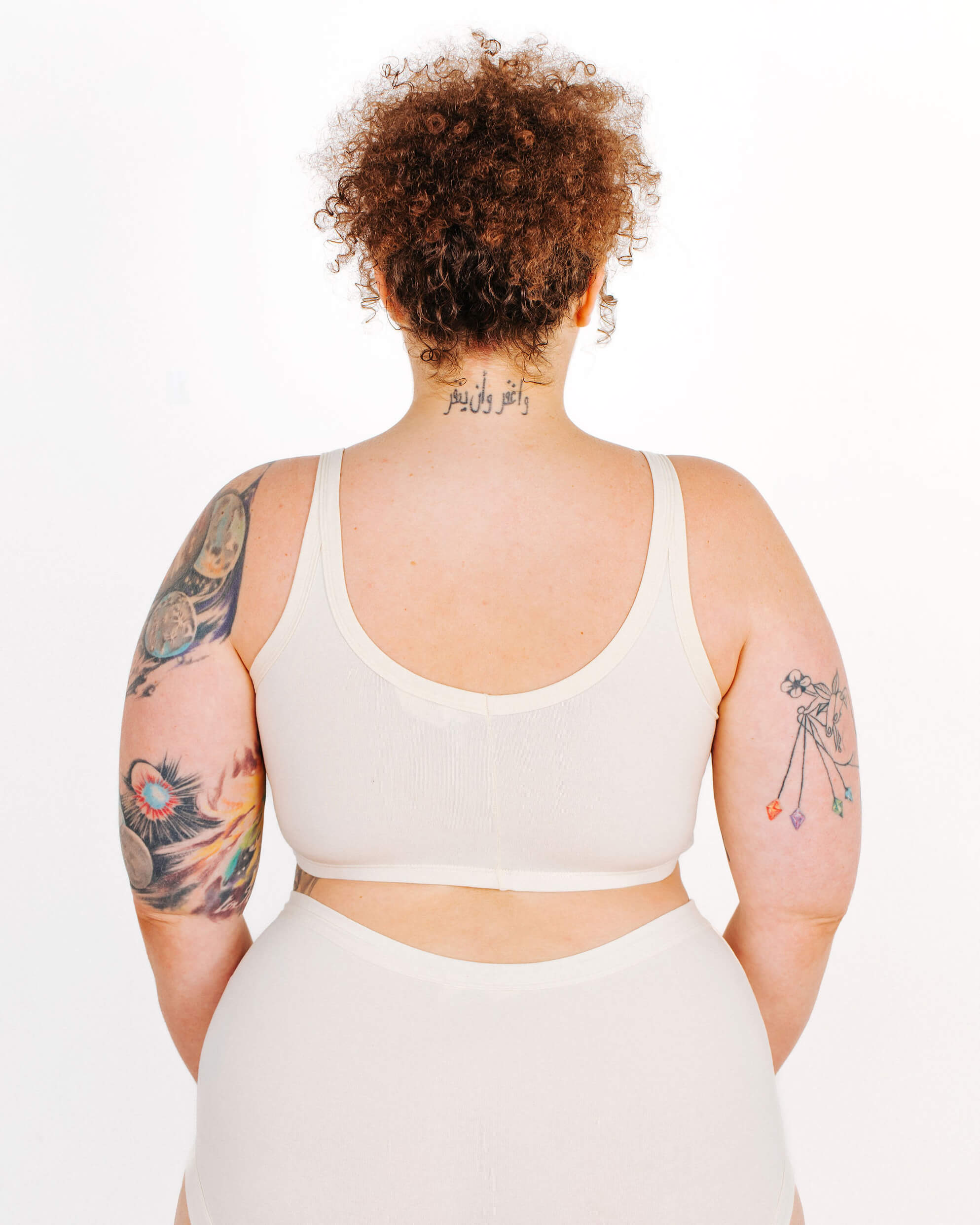 Fit photo from the back of Thunderpants organic cotton Longline Bra in off-white on a model.