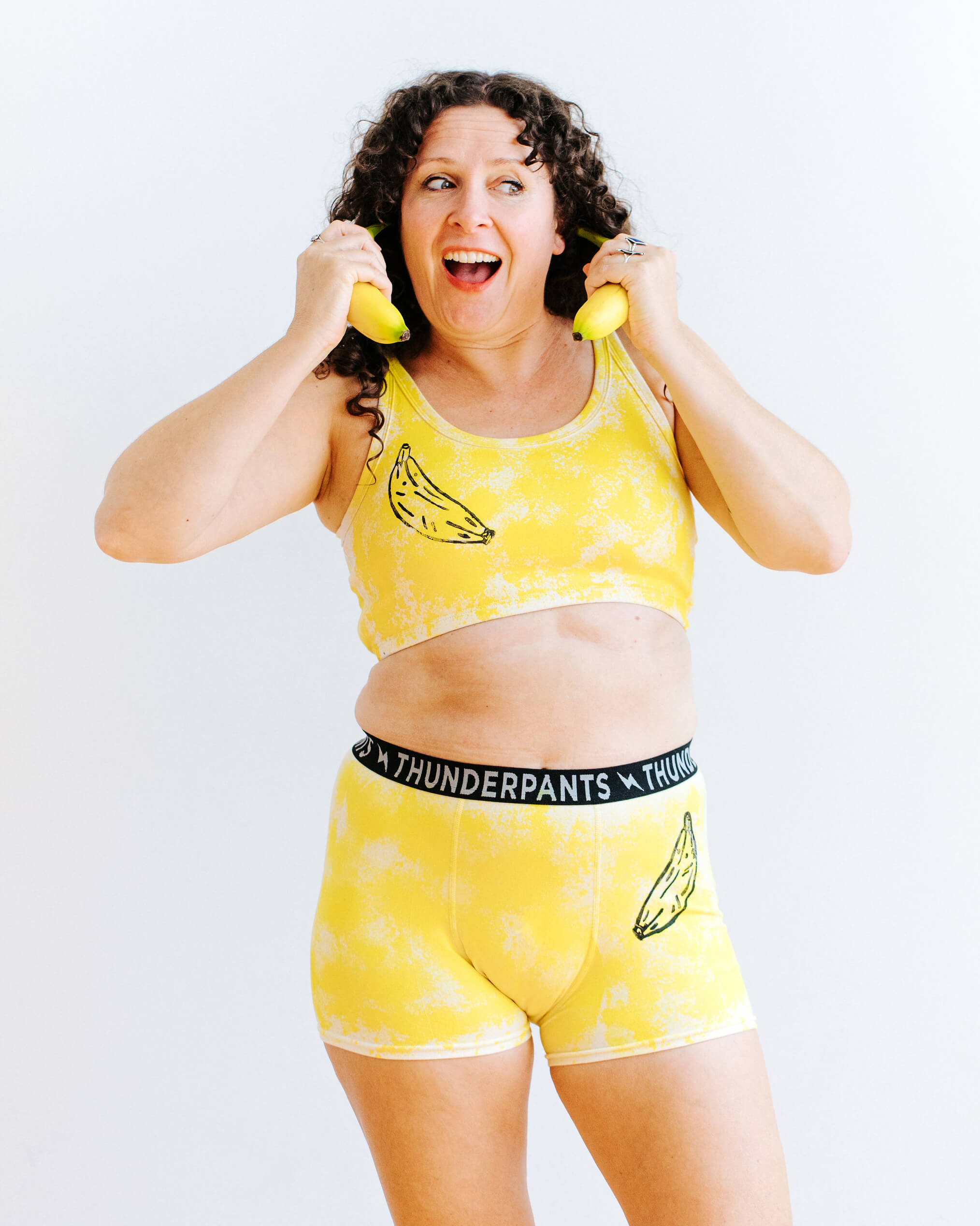 Model wearing Thunderpants Longline bra and Boxer Briefs in Banana Pitch - yellow with black banana print.