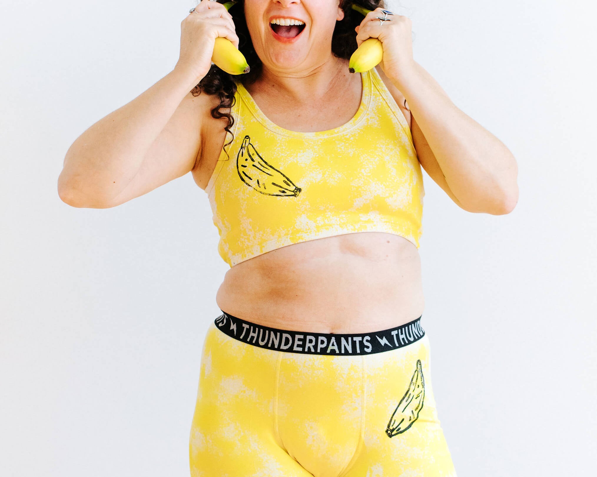 Model wearing Thunderpants Longline bra and Boxer Briefs in Banana Pitch - yellow with black banana print.