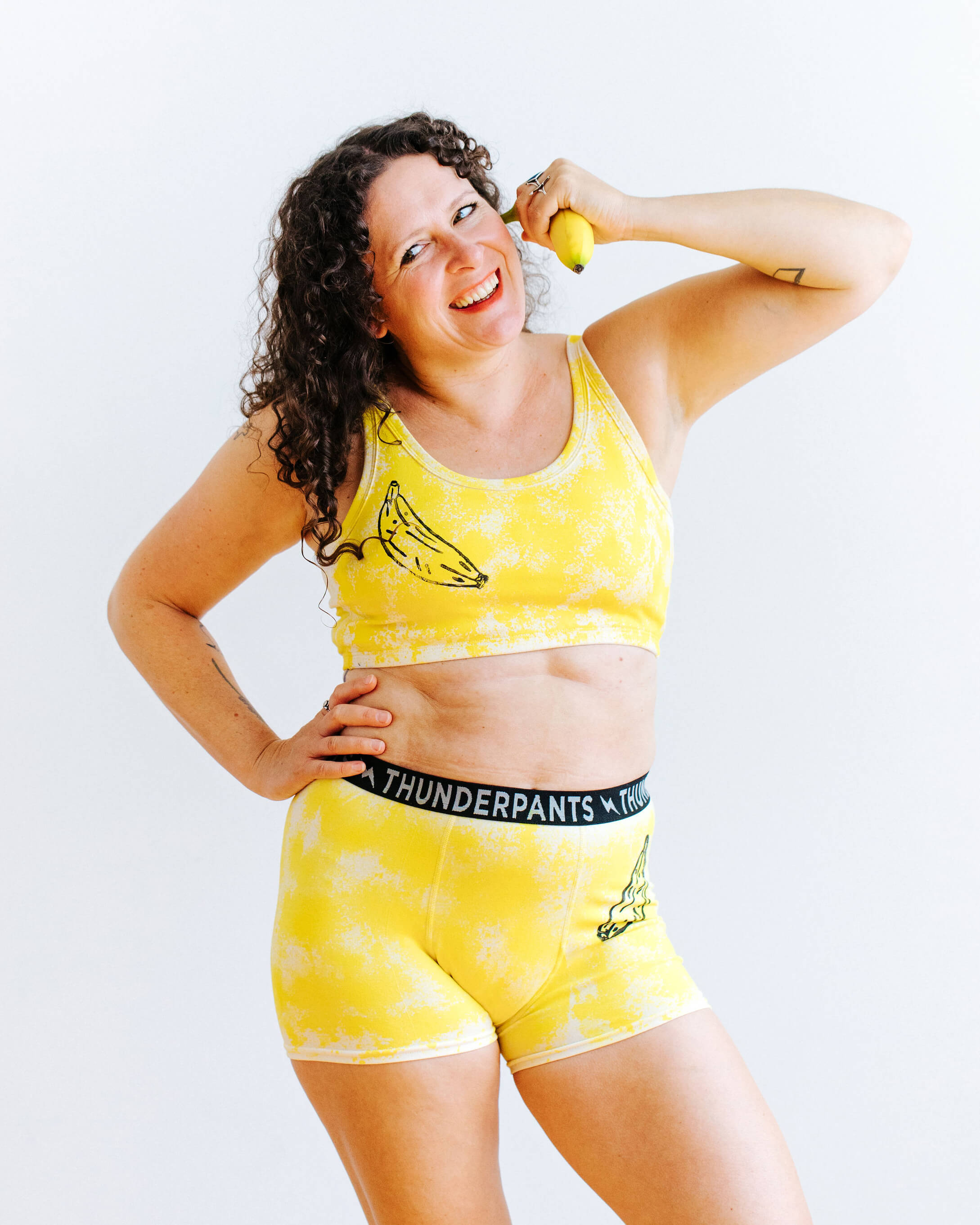 Model wearing Thunderpants Longline bra and Boxer Briefs in Banana Pitch - yellow with black banana print.