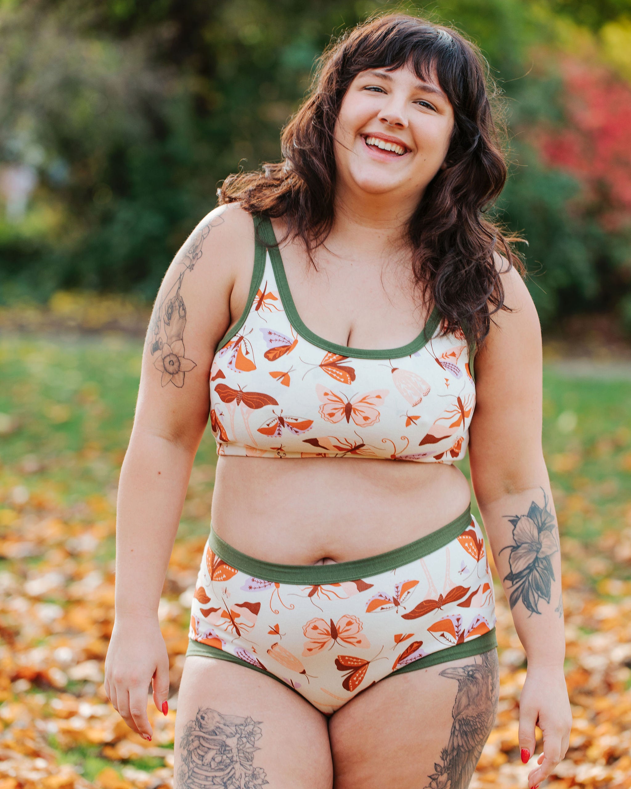 Model wearing Thunderpants Longline Bra and Sky Rise style underwear in Field Study: a moth print in red, orange, pink, and purple bound in green.