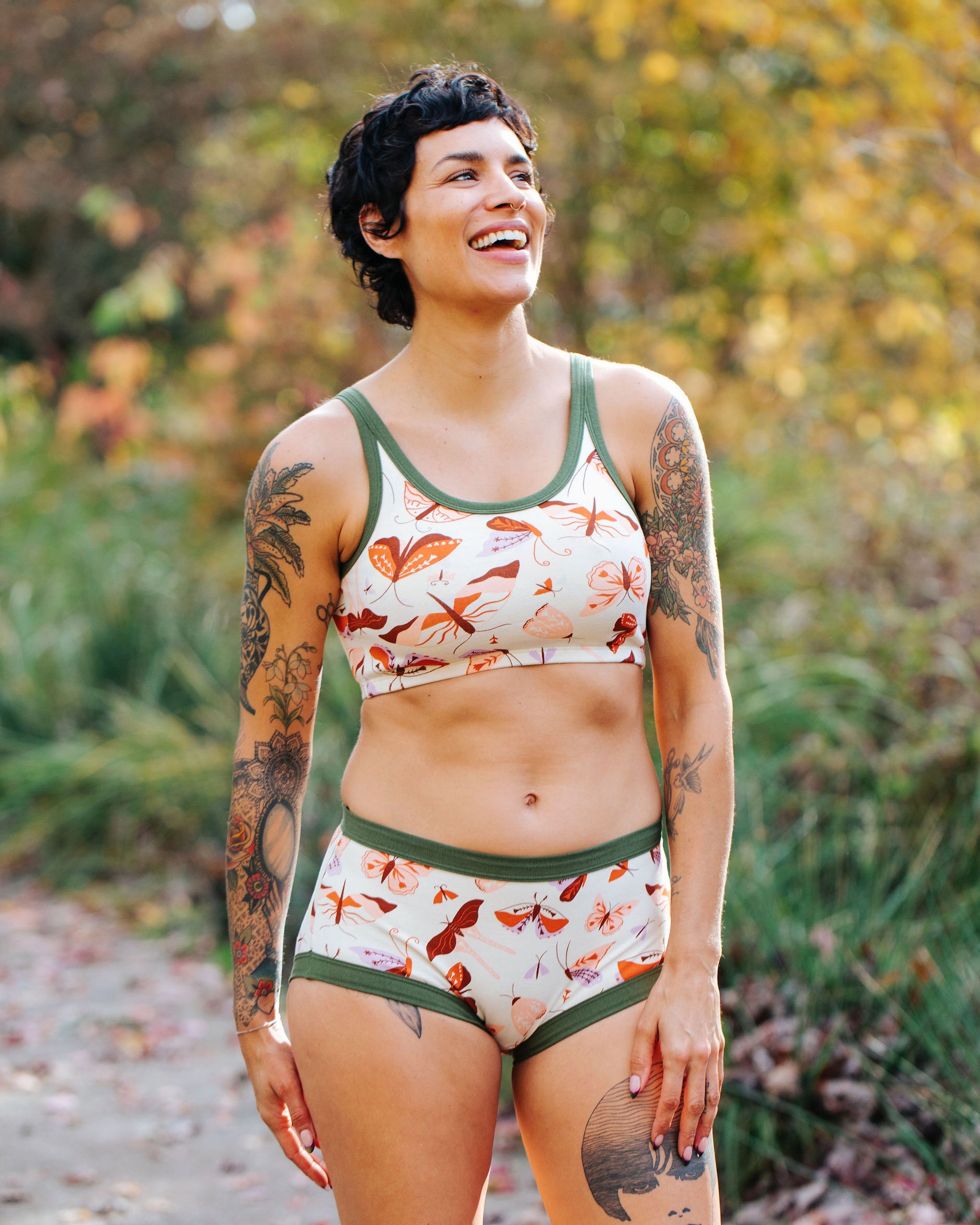 Model wearing Thunderpants Longline Bra and Original style underwear in Field Study: a moth print in red, orange, pink, and purple bound in green.