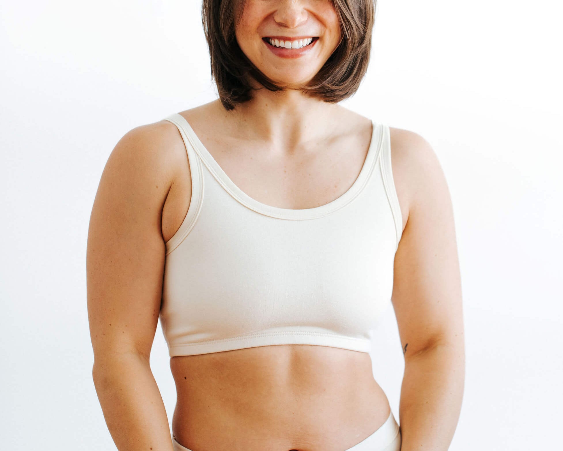 Fit photo from the front of Thunderpants organic cotton Longline Bra in off-white on a model.