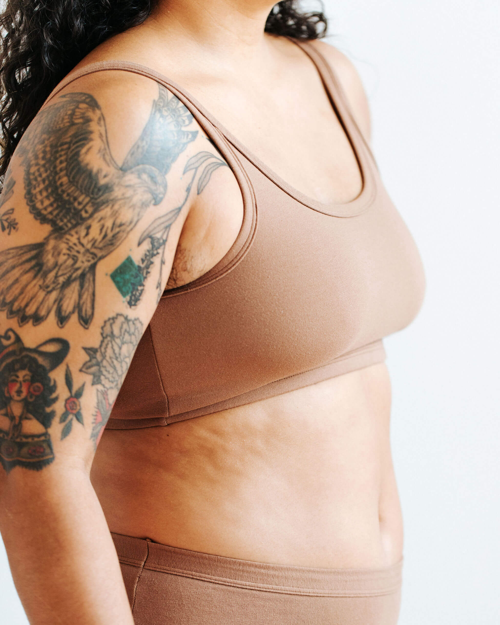 Close up of mdel wearing Thunderpants Longline Bra in Hazelnut color.