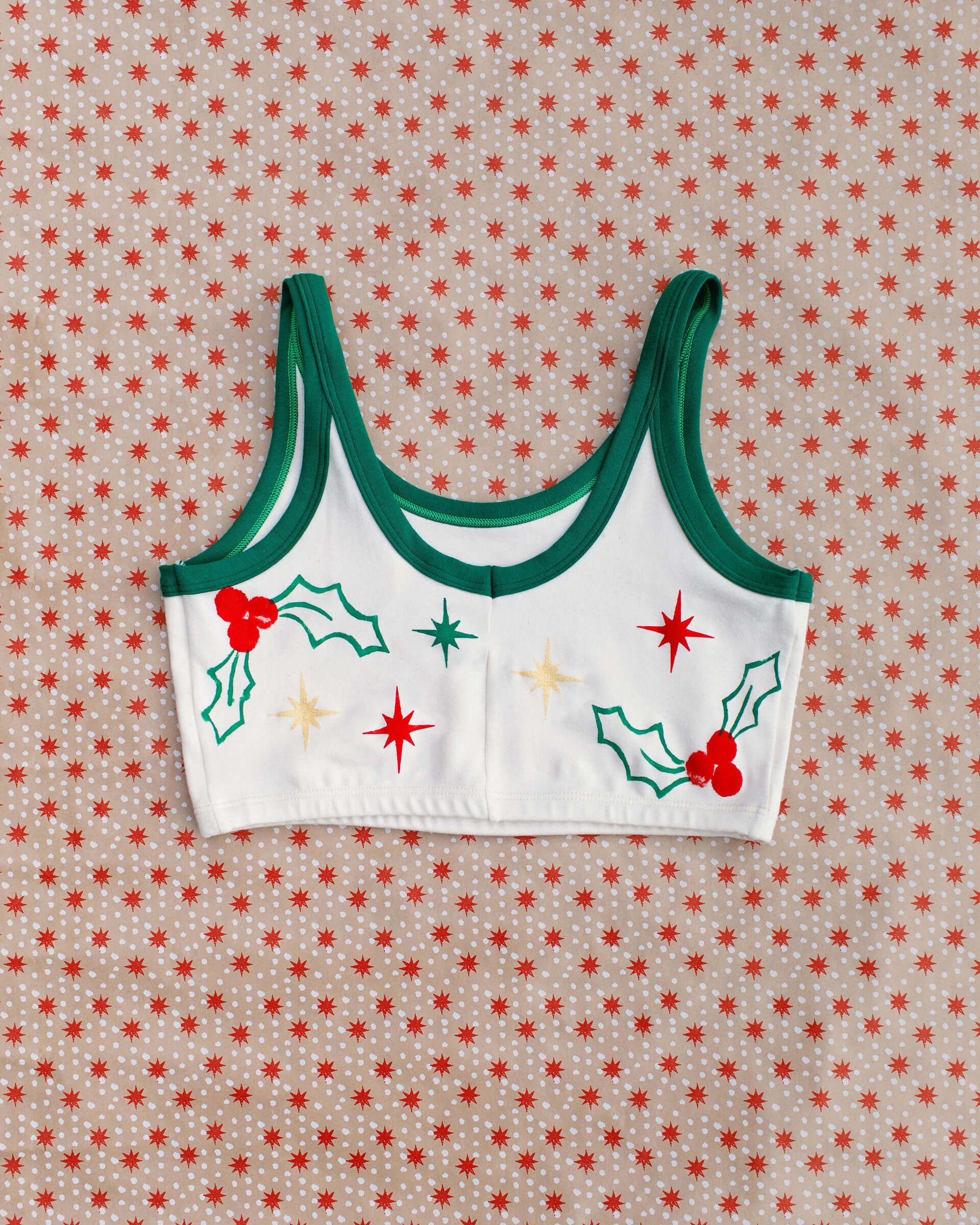 Flat lay of Thunderpants Longline Bra in Holly Holiday Handprint.