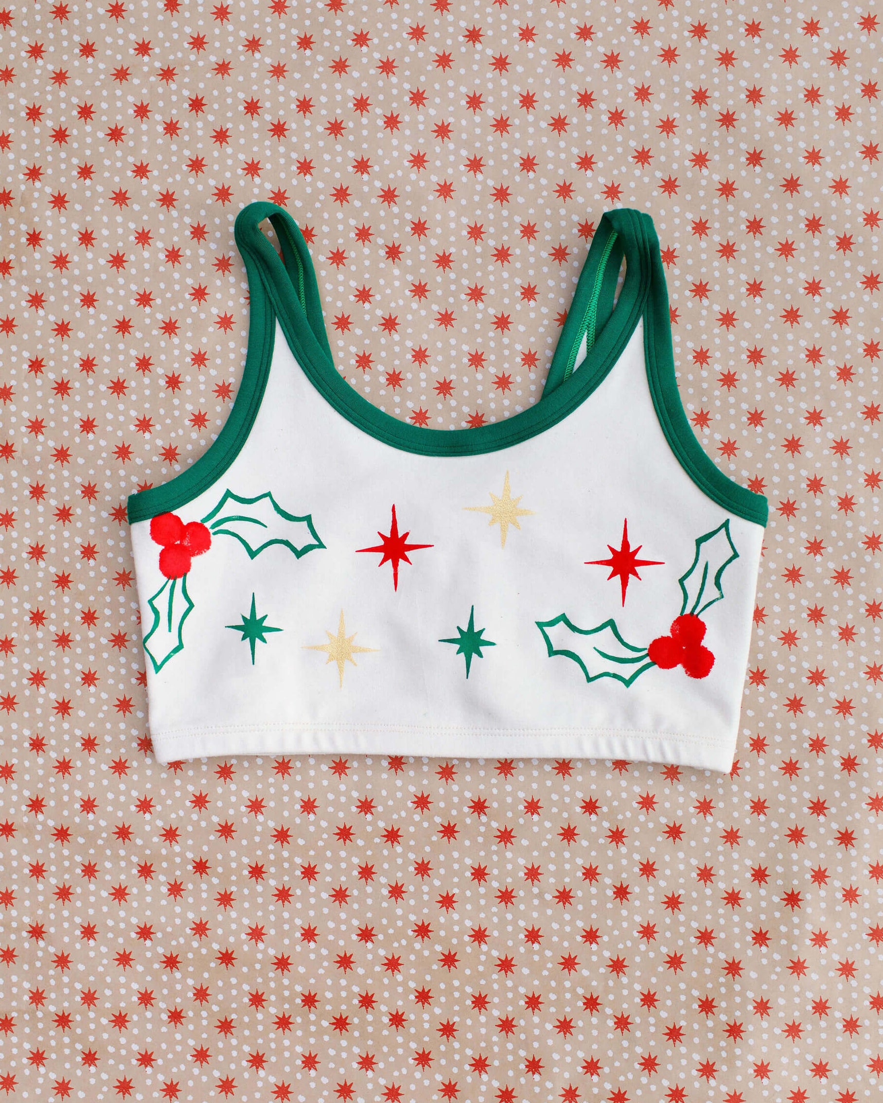 Flat lay of Thunderpants Longline Bra in Holly Holiday Handprint.