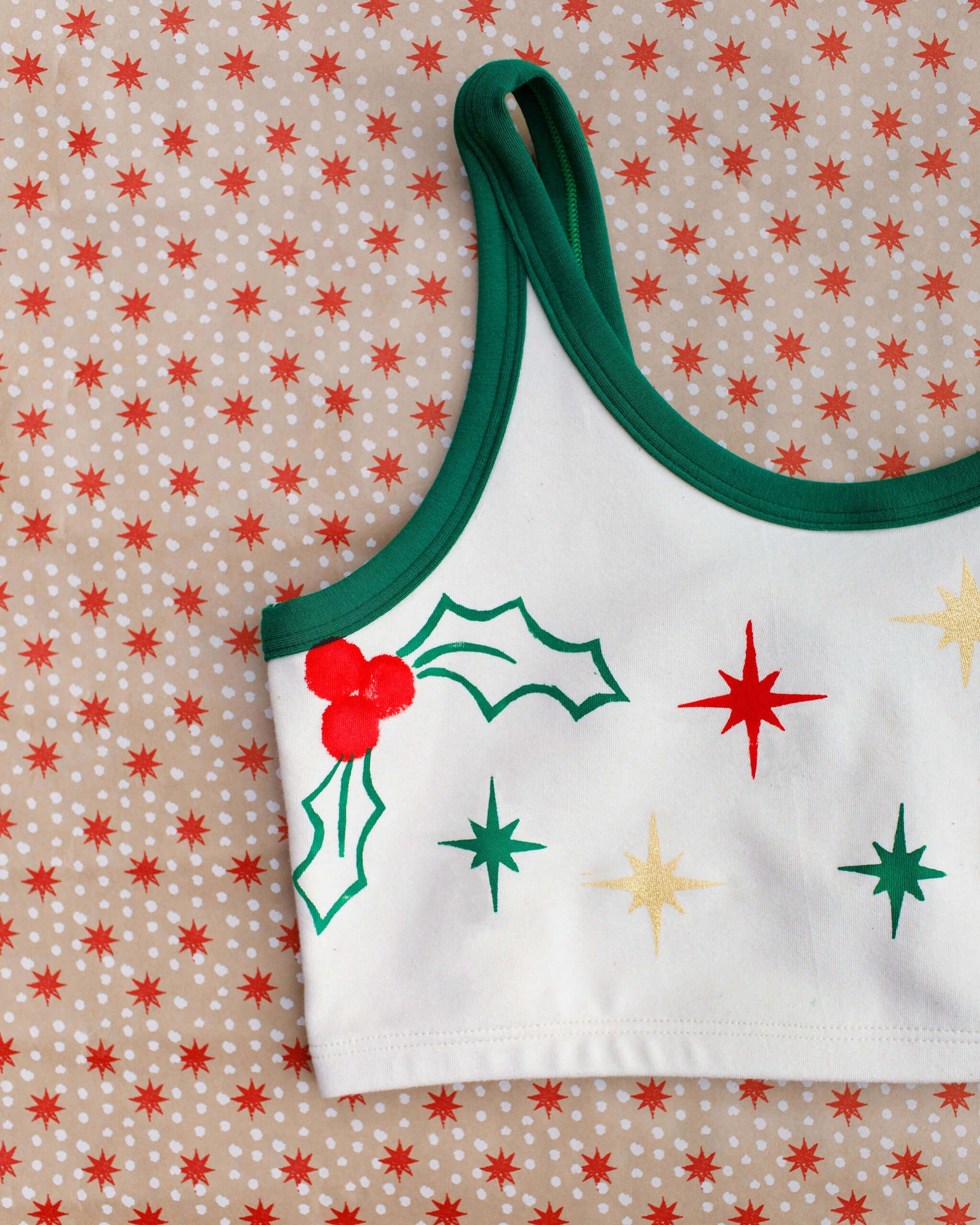 Close up flat lay of Thunderpants Longline Bra in Holly Holiday Handprint.