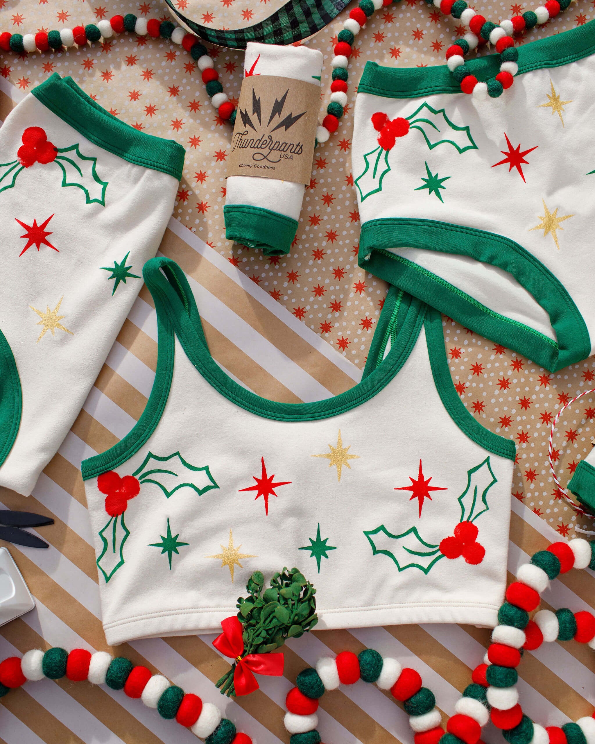 Flat lay of Thunderpants Longline Bra in Holly Holiday Handprint.