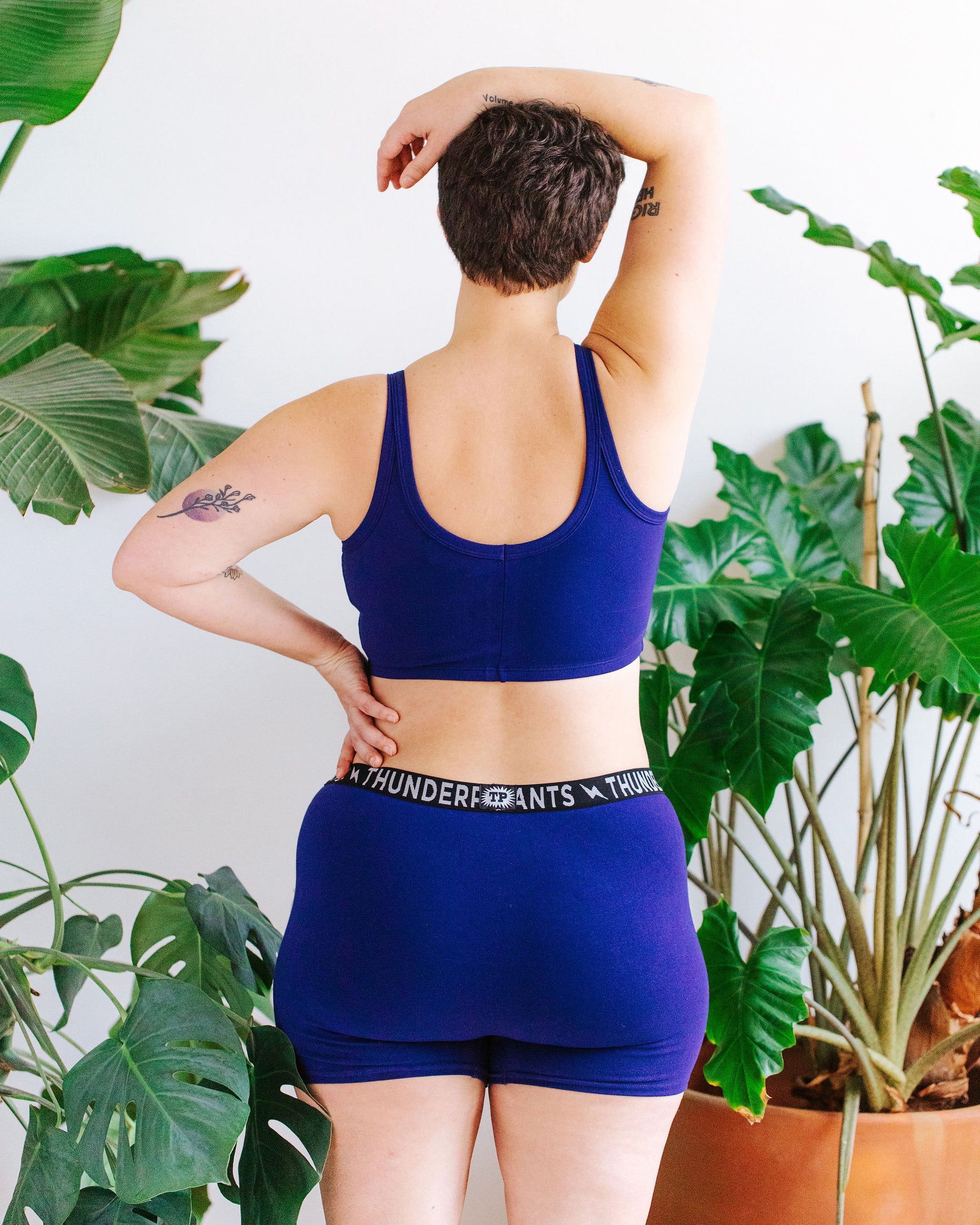 Model wearing Thunderpants Longline Bra and Boxer Brief style underwear in Indigo Blue.
