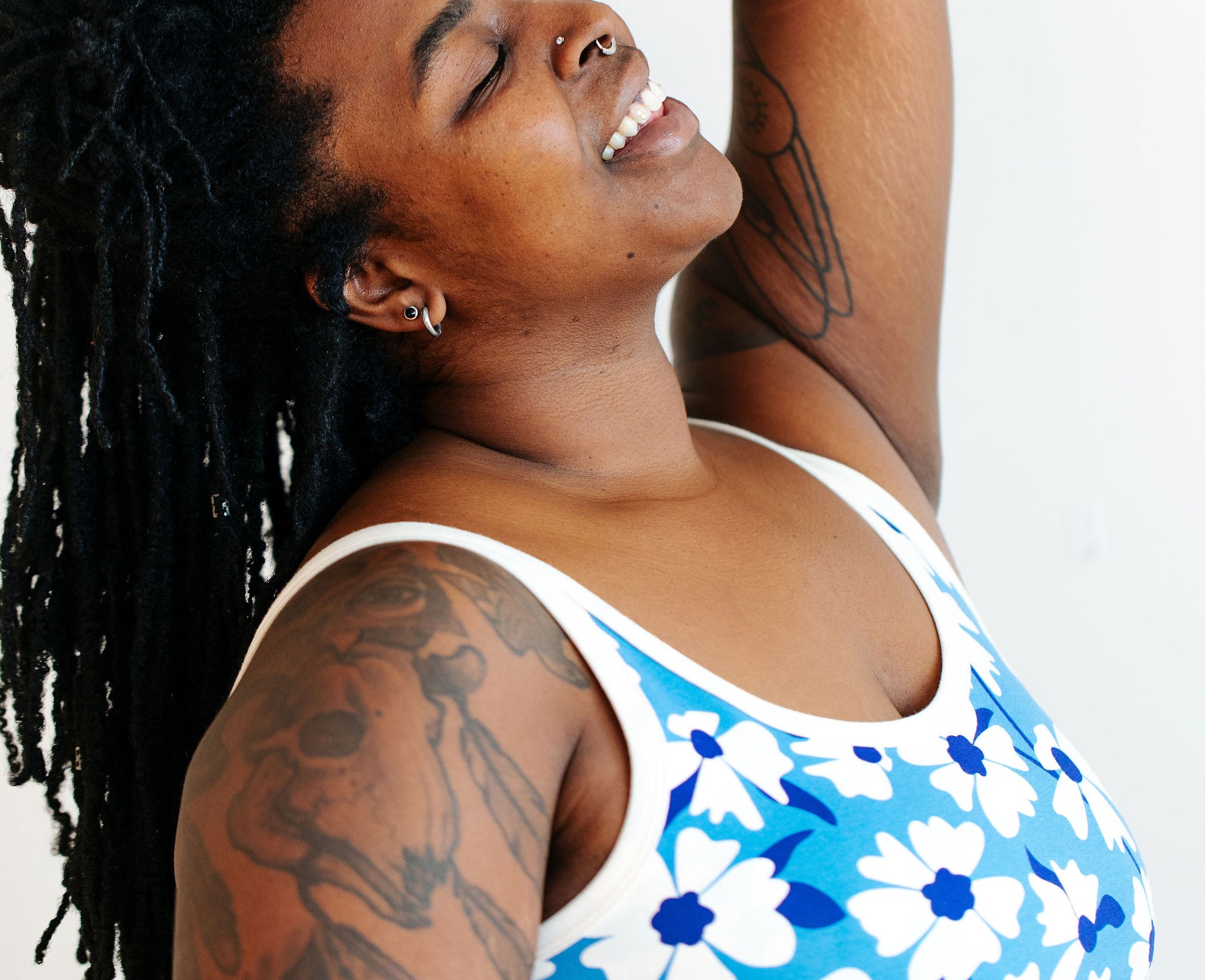 Model wearing Thunderpants Longline Bra in Moody Blooms - white and blue flowers with blue background.