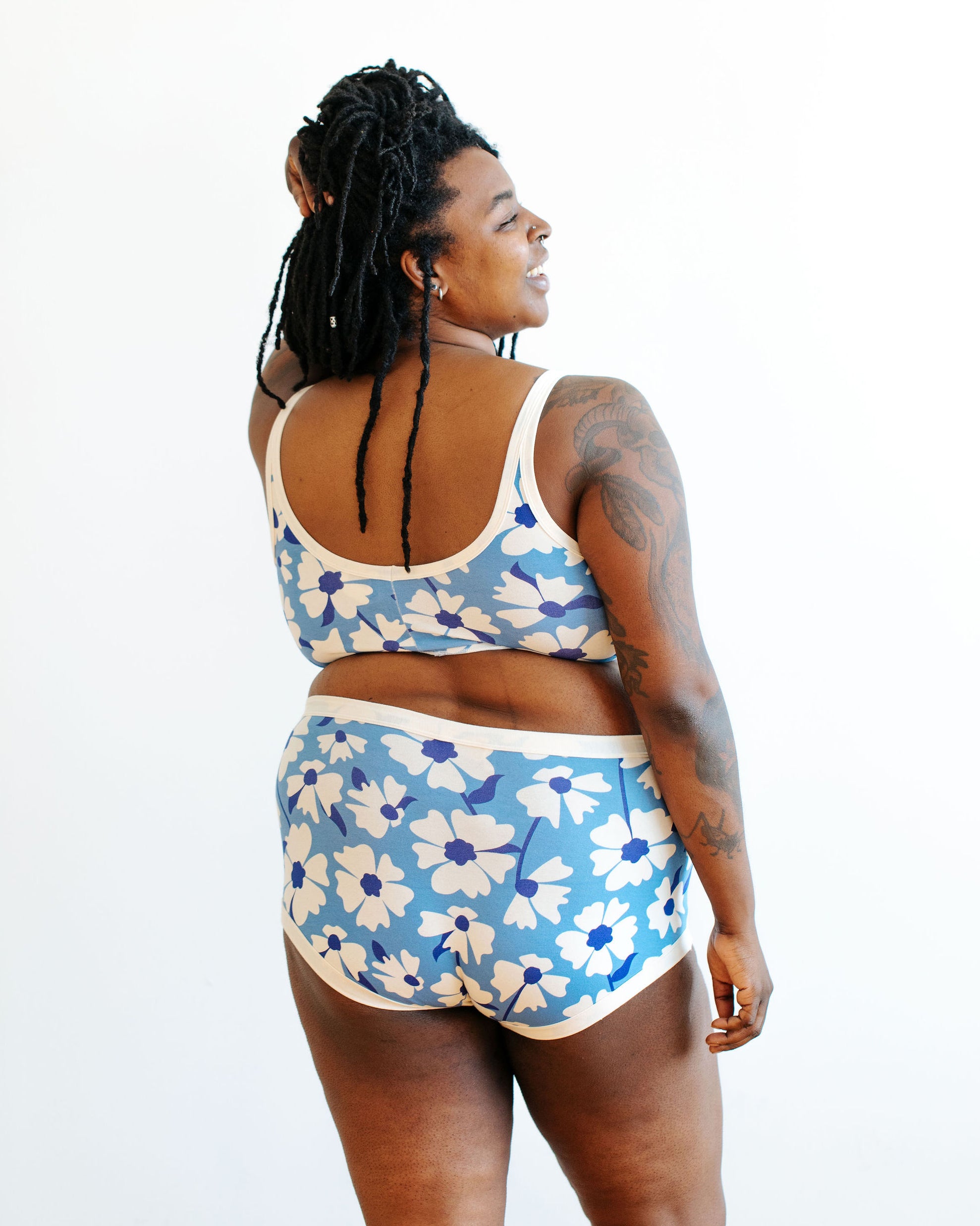 Model wearing Thunderpants Longline Bra and Original style underwear in Moody Blooms - white and blue flowers with blue background.