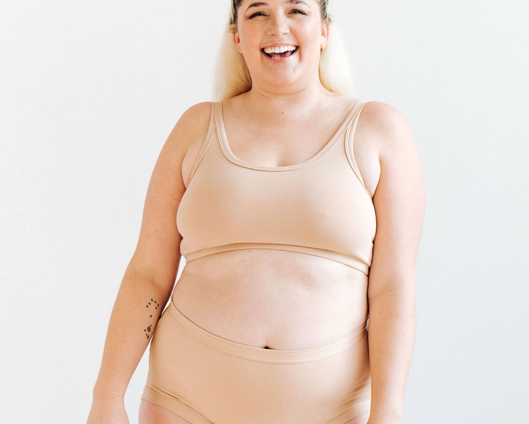 Model wearing Thunderpants Longline Bra and Original style underwear in Pine Nut - lighter tan color.