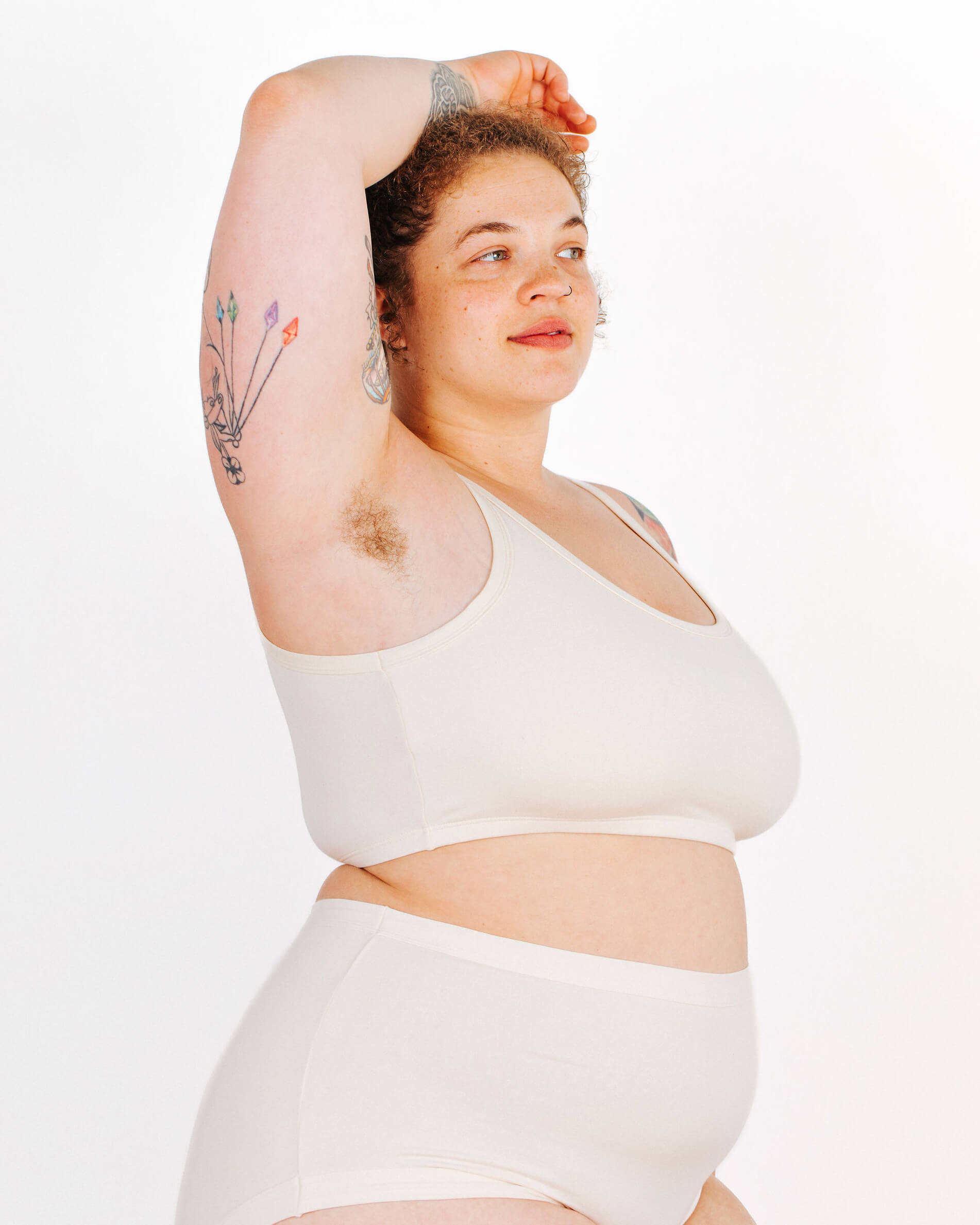 Fit photo from the side of Thunderpants organic cotton Longline Bra in off-white on a model.