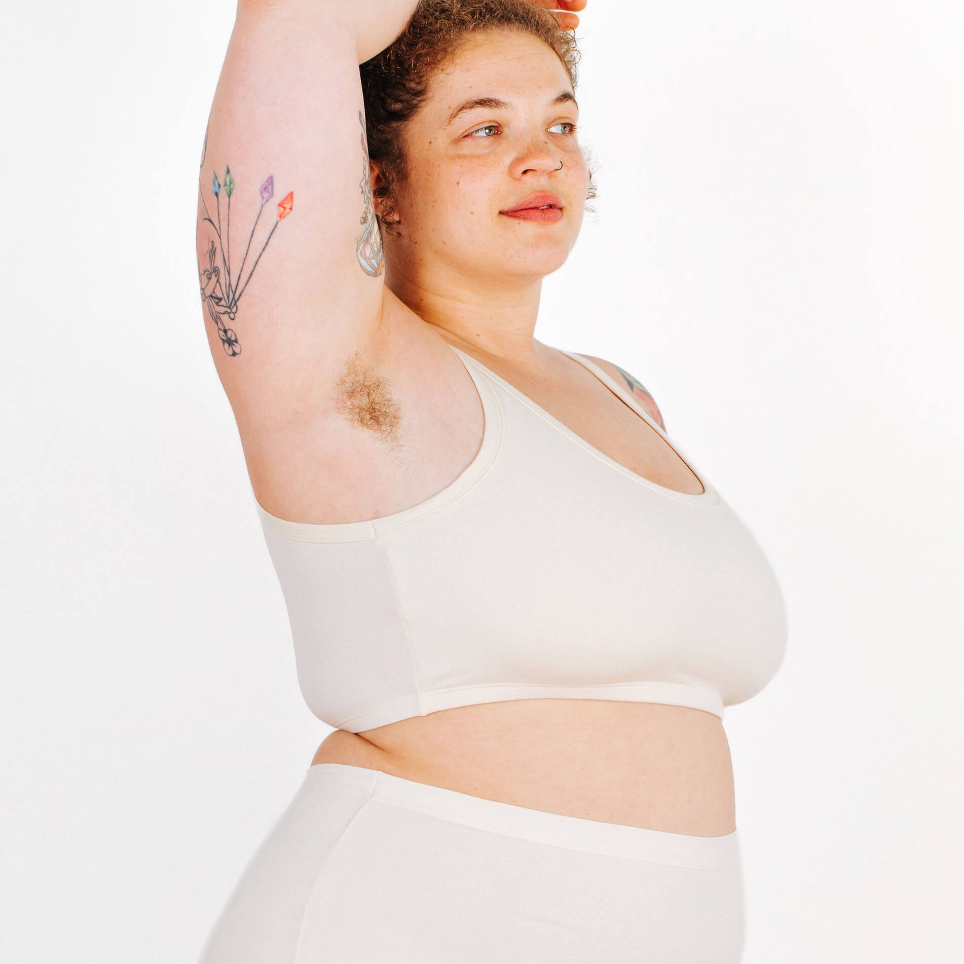 Fit photo from the side of Thunderpants organic cotton Longline Bra in off-white on a model.