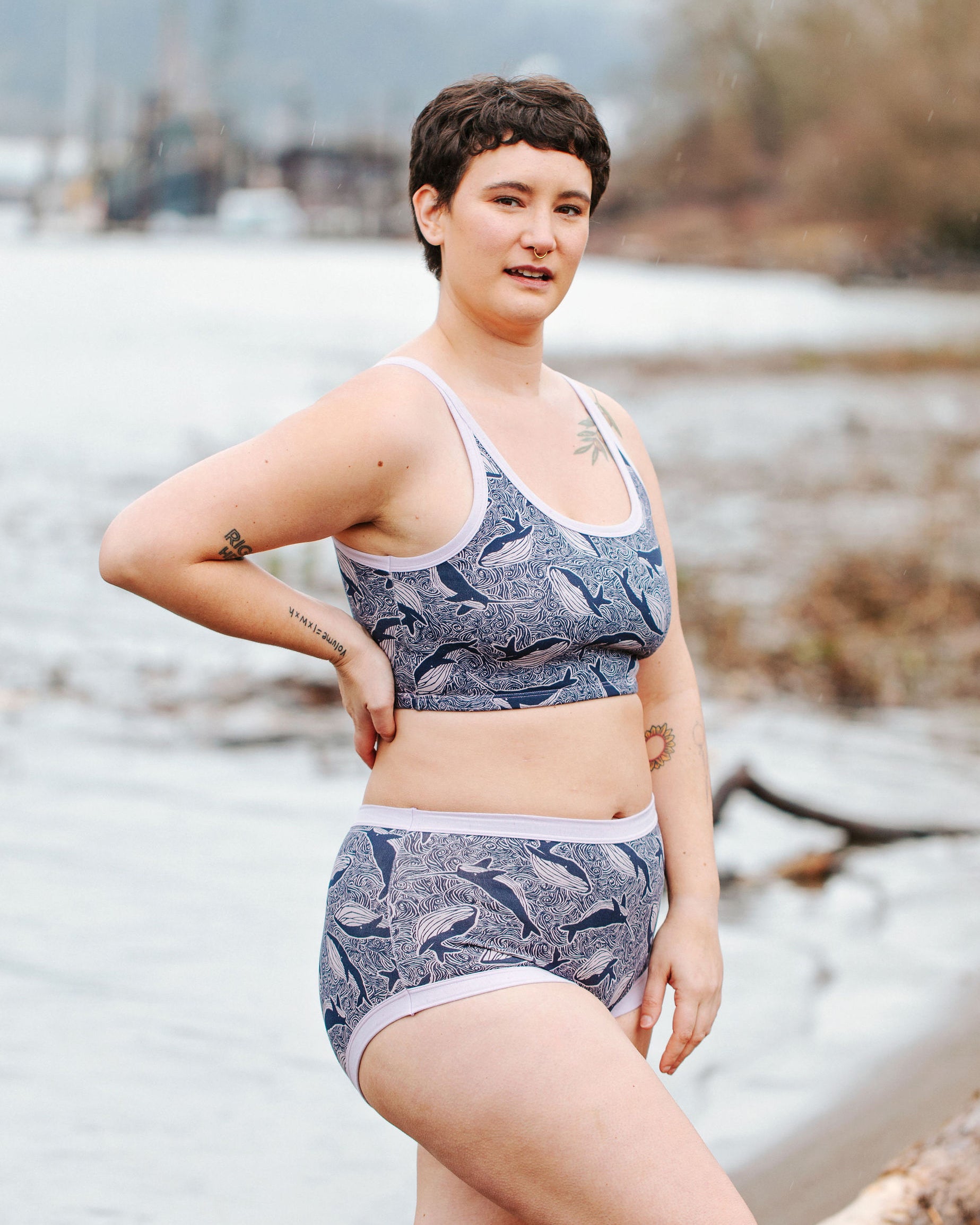 Model wearing Thunderpants Longline Bra  and Original style underwear in Whale, Whale, Whale - indigo whales on lavender.