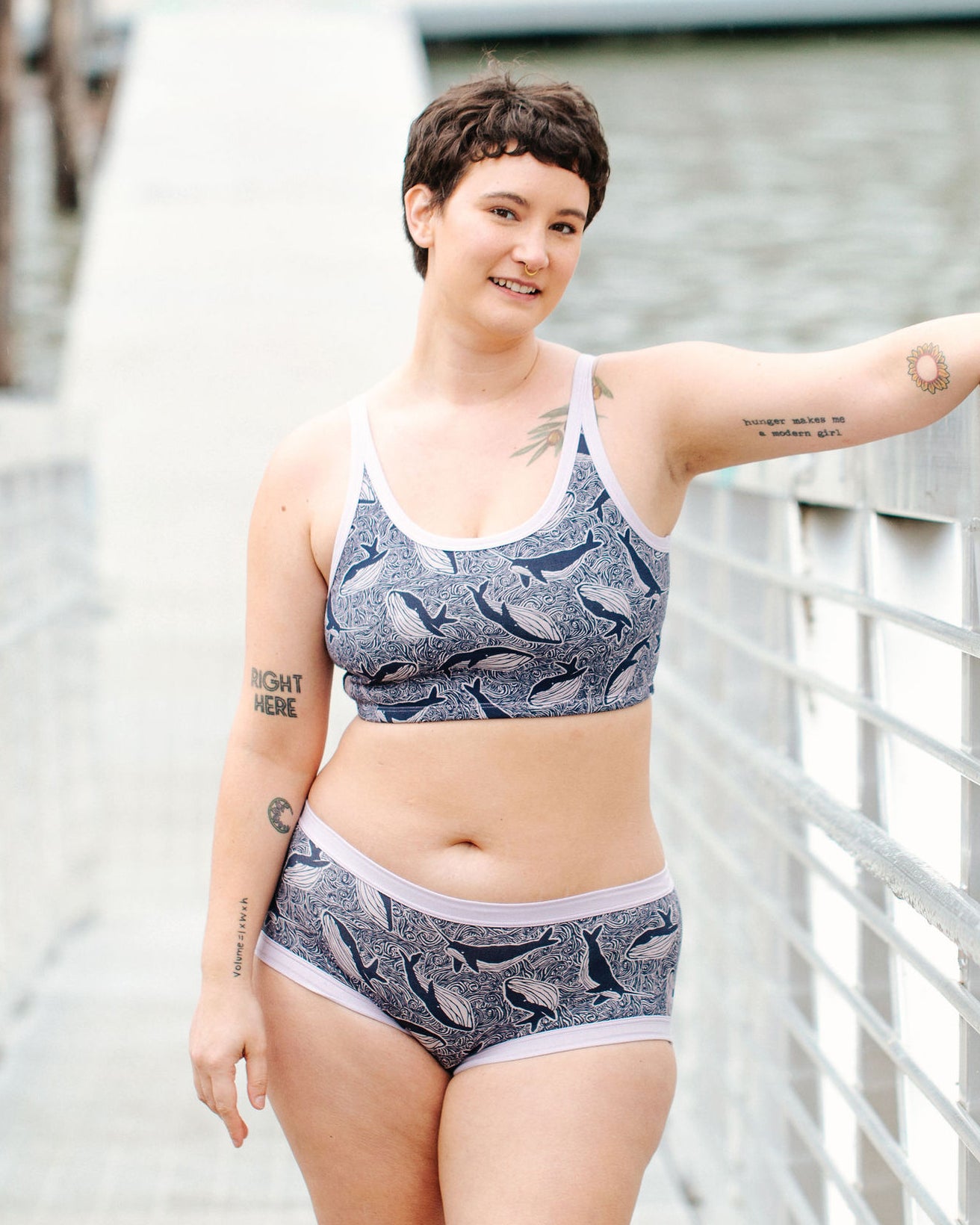 Model wearing Thunderpants Longline Bra  and Hipster style underwear in Whale, Whale, Whale - indigo whales on lavender.