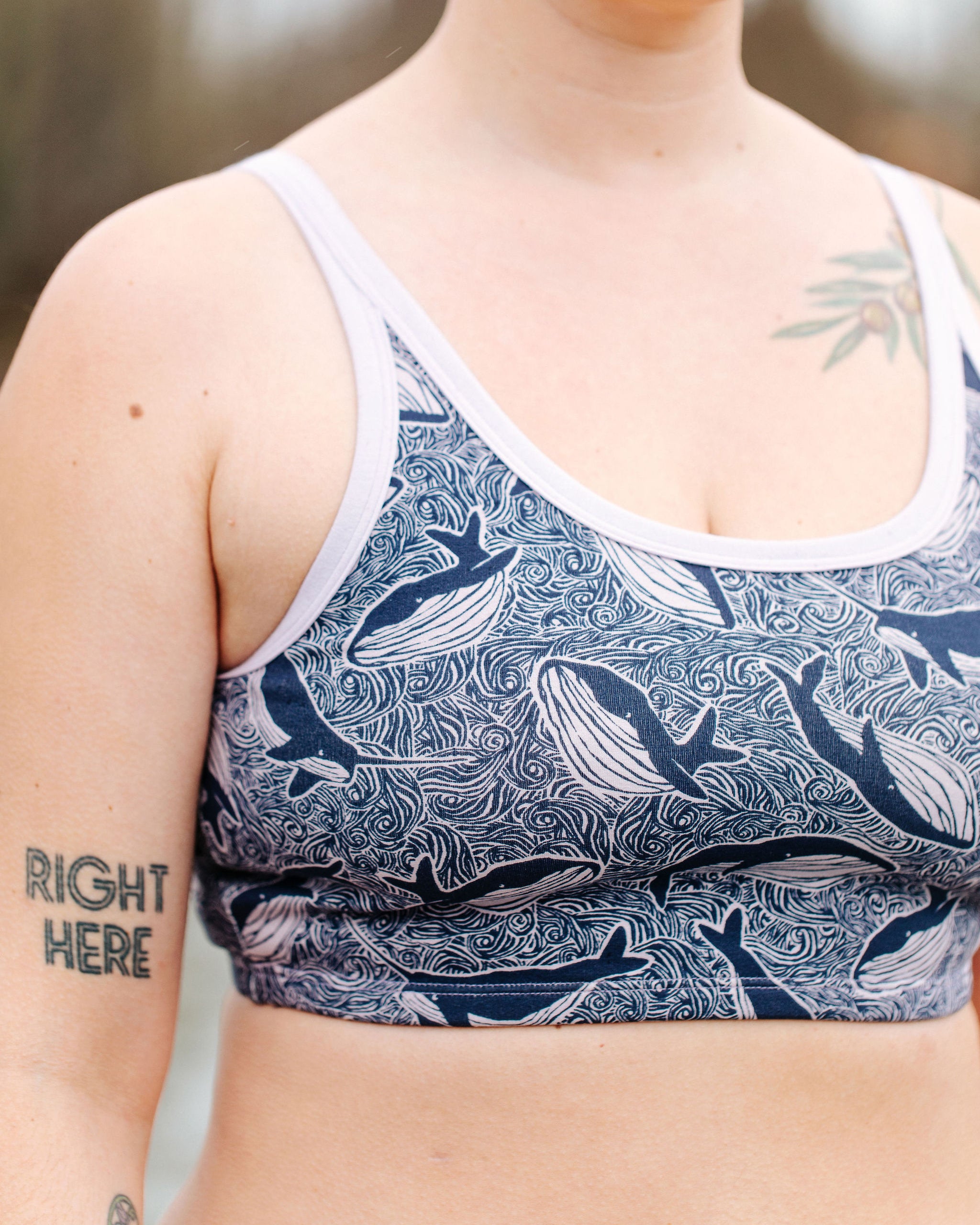 Model wearing Thunderpants Longline Bra in Whale, Whale, Whale - indigo whales on lavender.