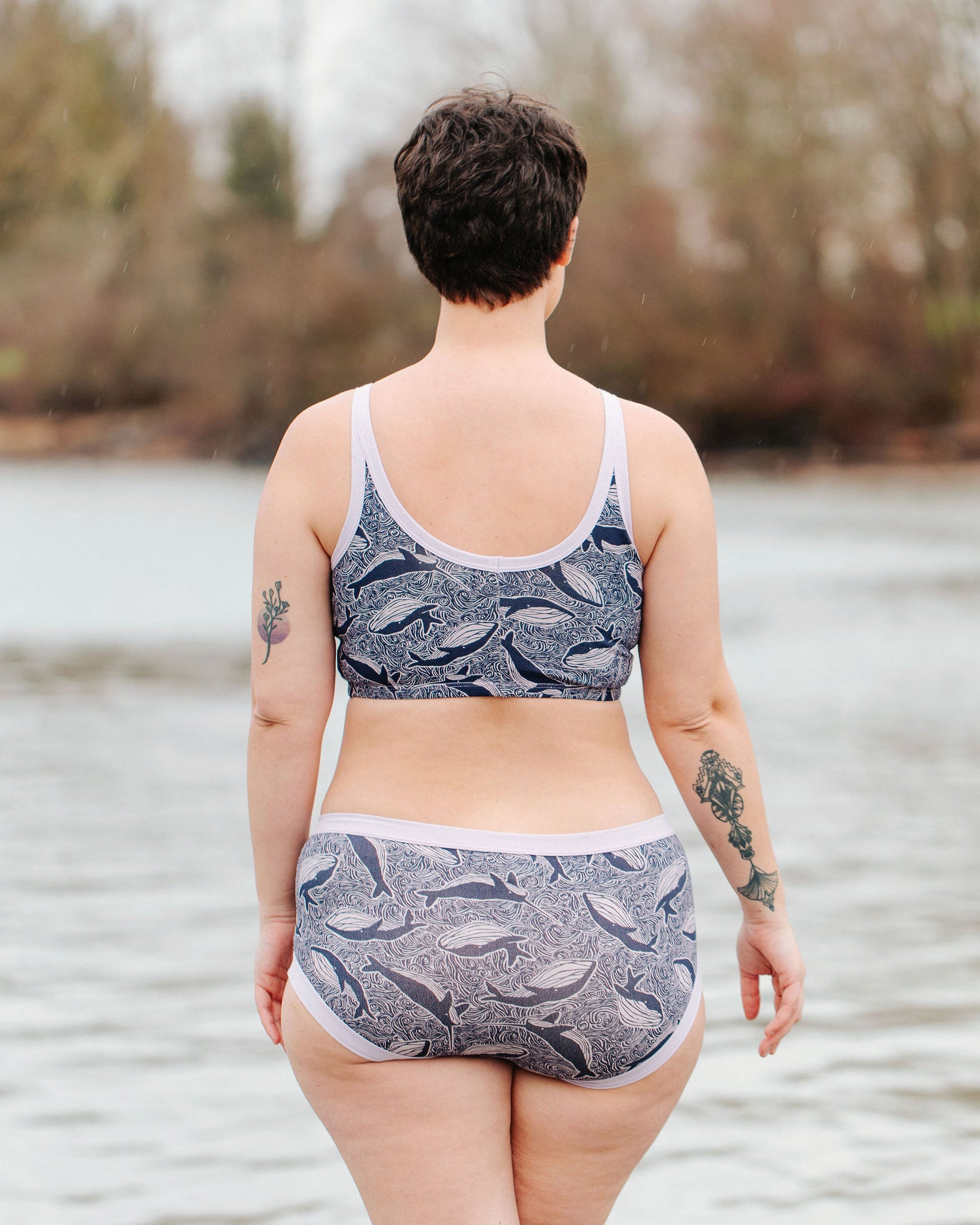 Model wearing Thunderpants Longline Bra  and Hipster style underwear in Whale, Whale, Whale - indigo whales on lavender.
