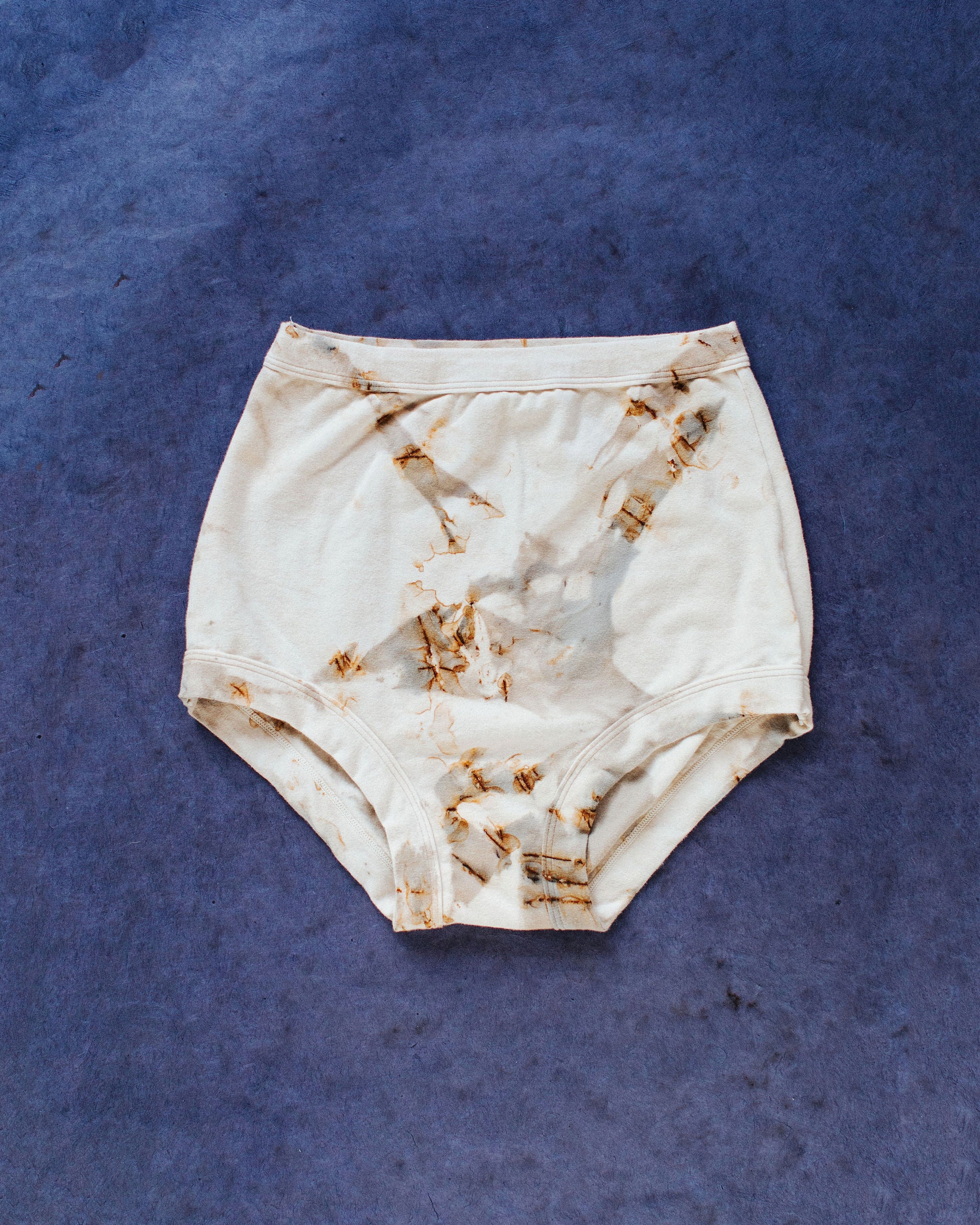 Flat lay of Thunderpants Sky Rise style underwear in Mineral Rust Dye.