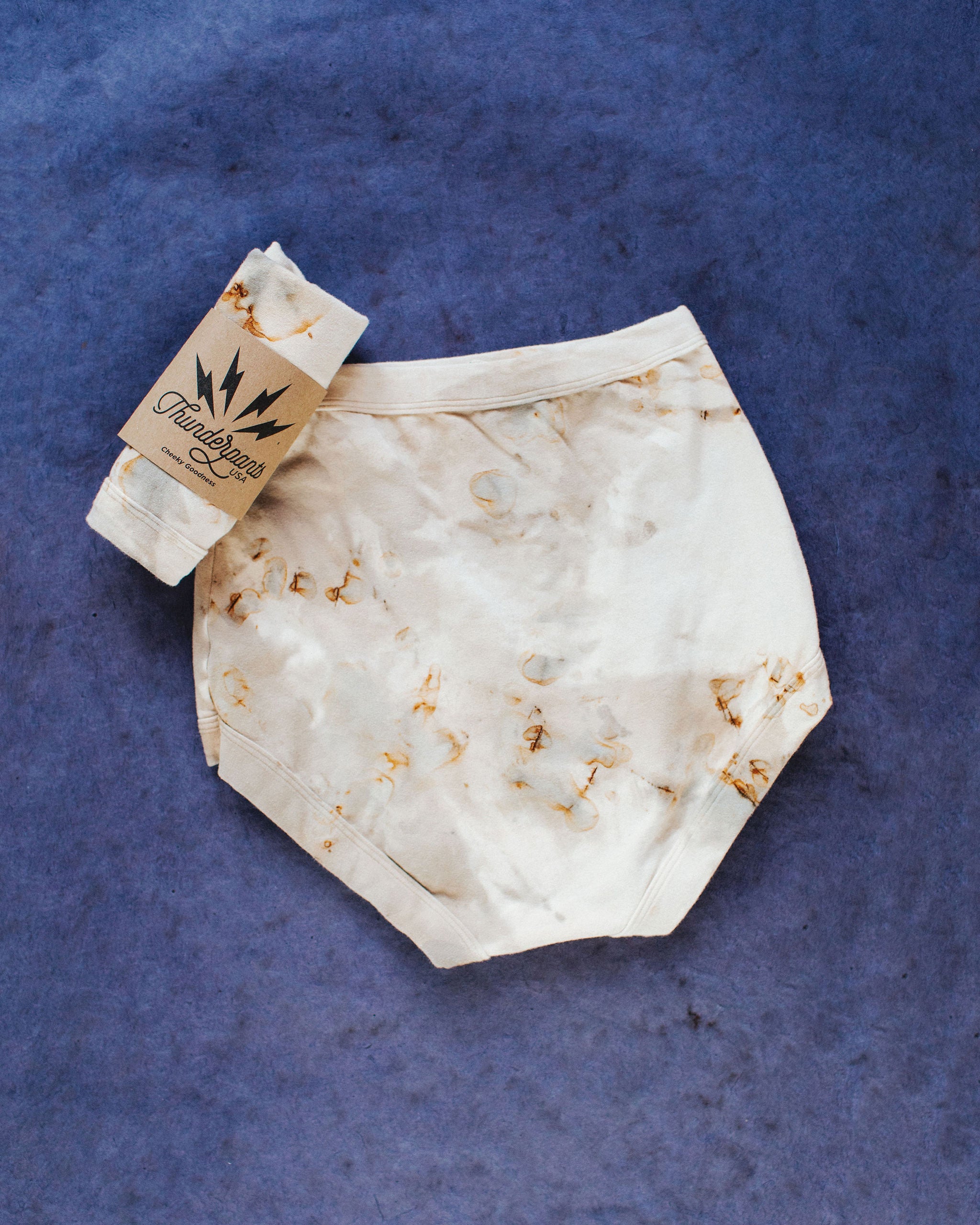 Flat lay of Thunderpants Sky Rise style underwear in Mineral Rust Dye.