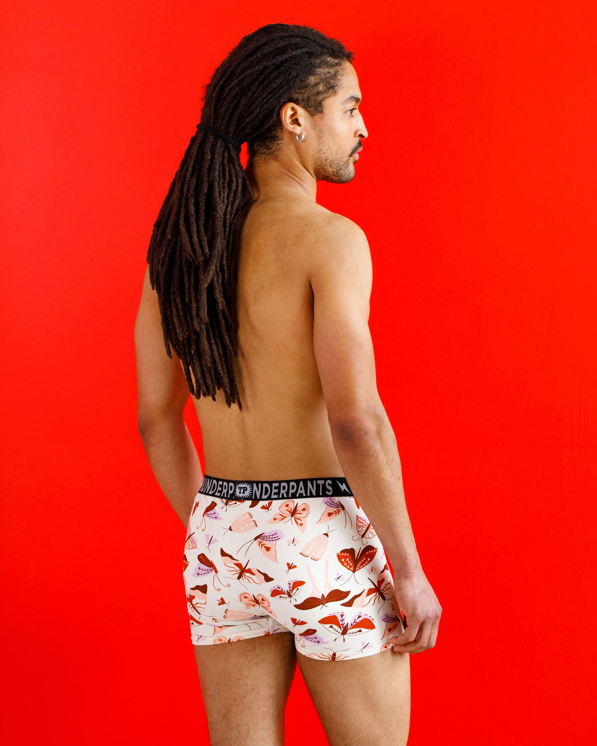 Male model wearing Thunderpants organic cotton Boxer Brief style underwear in a moth print.