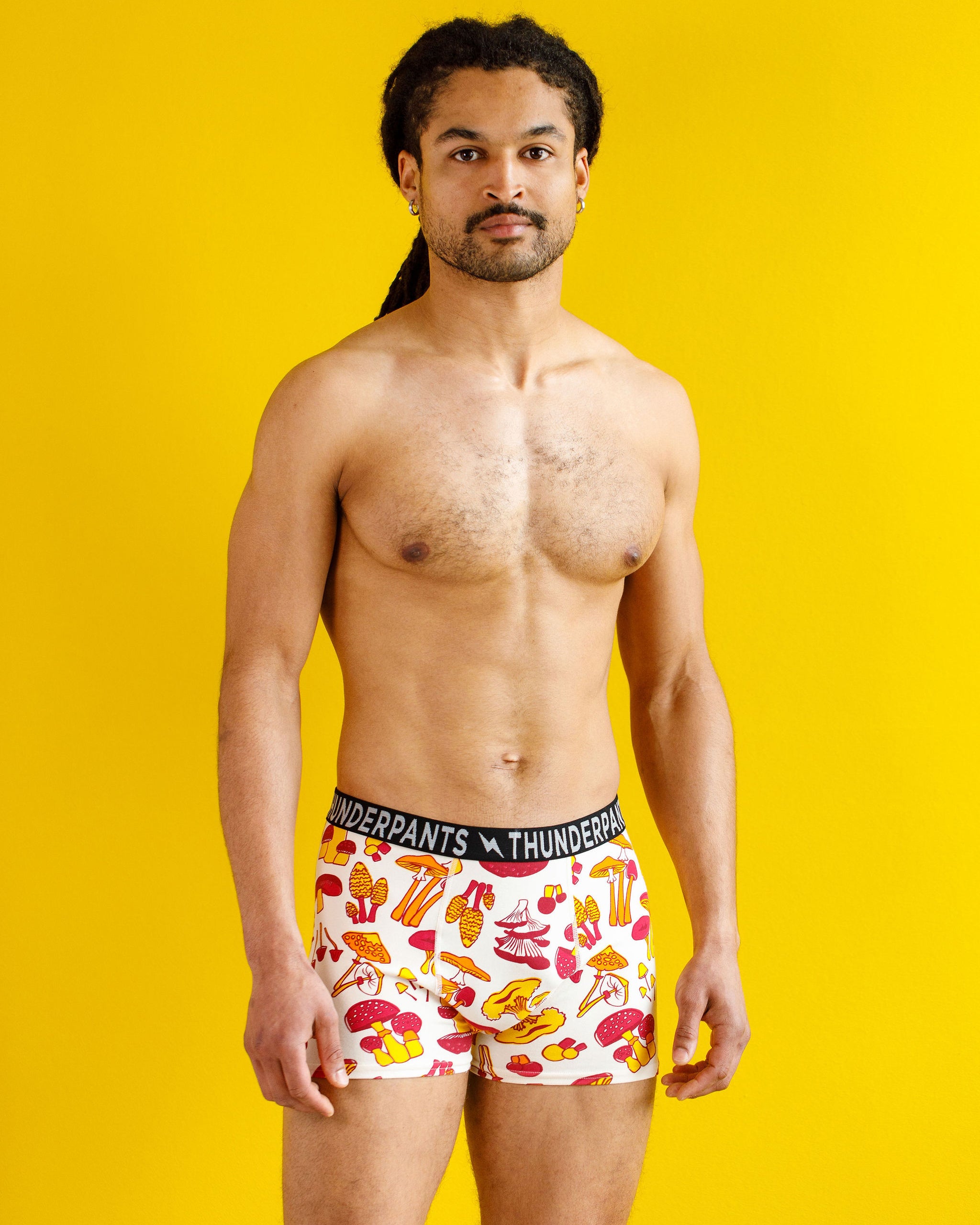 Male model wearing Thunderpants organic cotton Boxer Brief style underwear in a mushroom print.