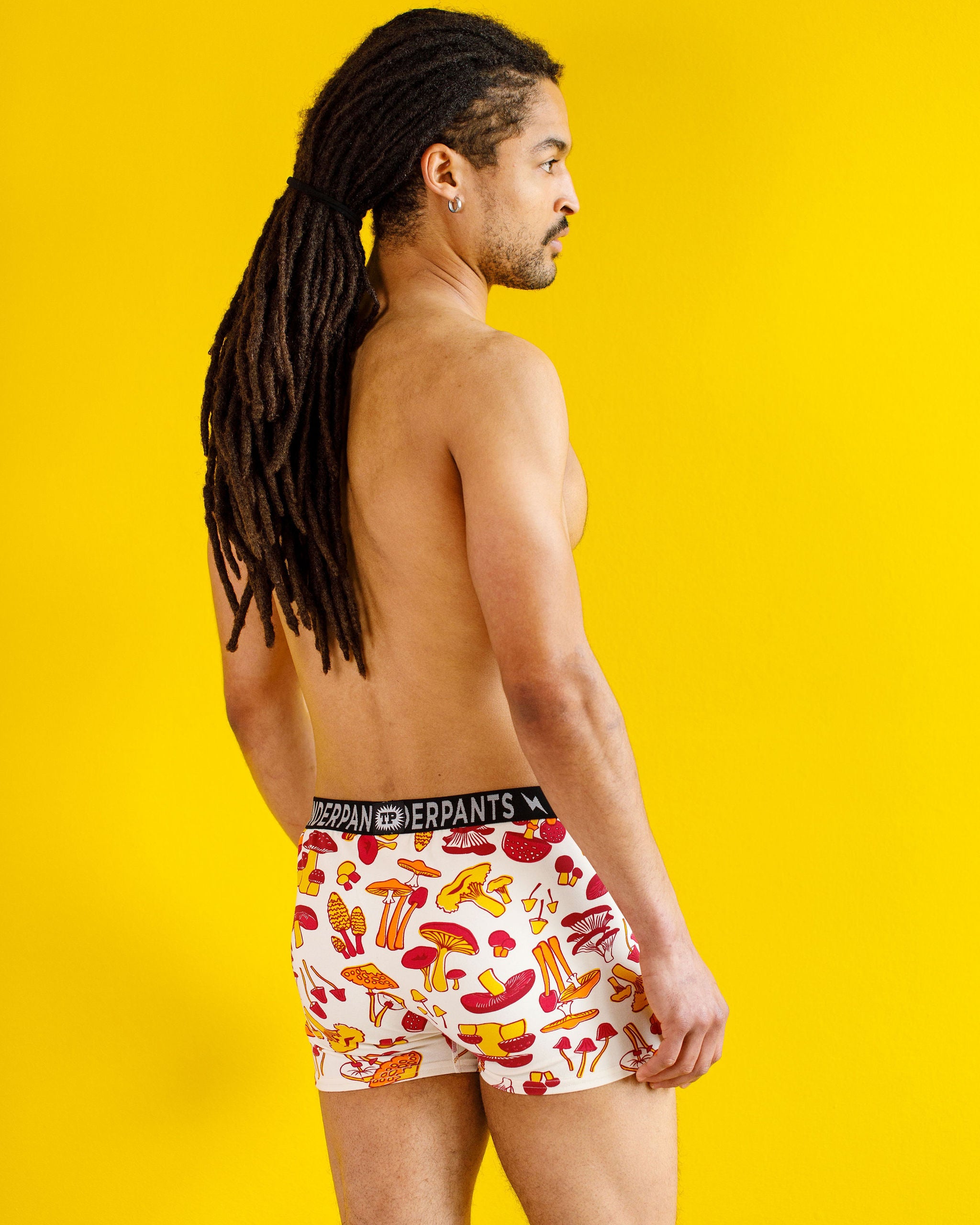 Male model wearing Thunderpants organic cotton Boxer Brief style underwear in a mushroom print.