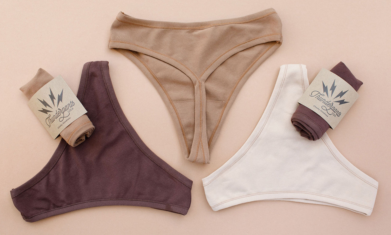 Flat lay of Thunderpants thong style underwear in Chestnut (dark brown), Hazelnut (mid brown), and Pine Nut (tan).