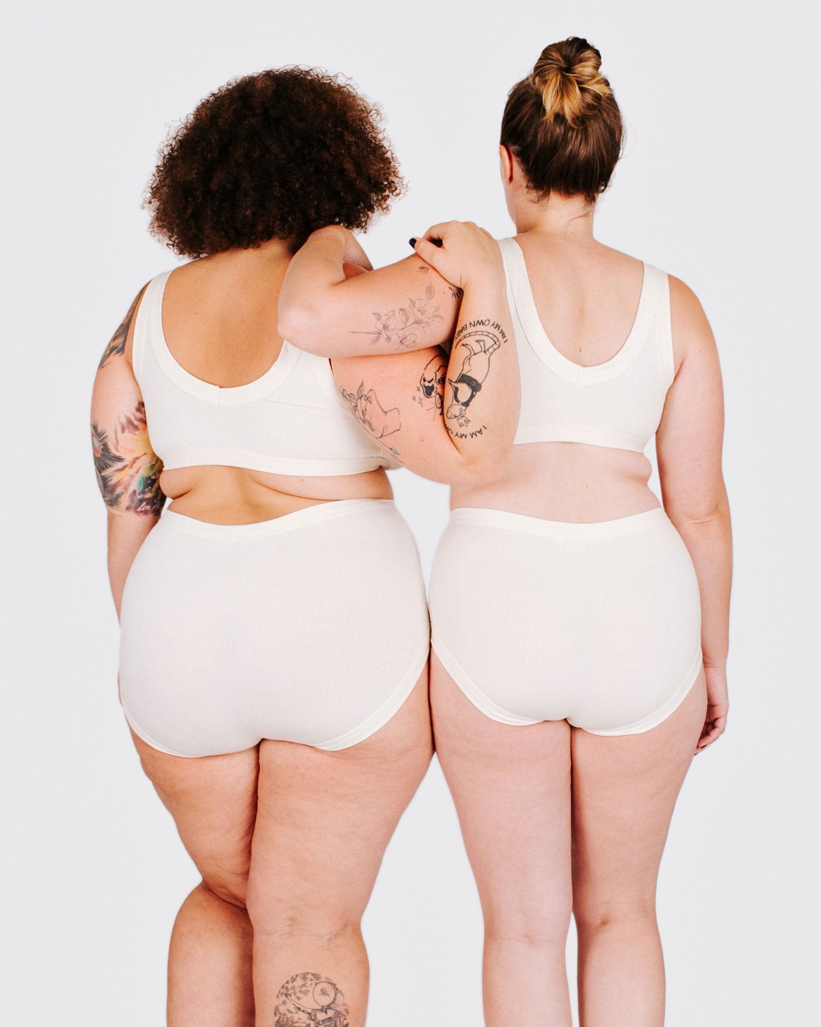 Fit photo from the back of Thunderpants organic cotton Original style underwear and Bralette in off-white on two model standing together.