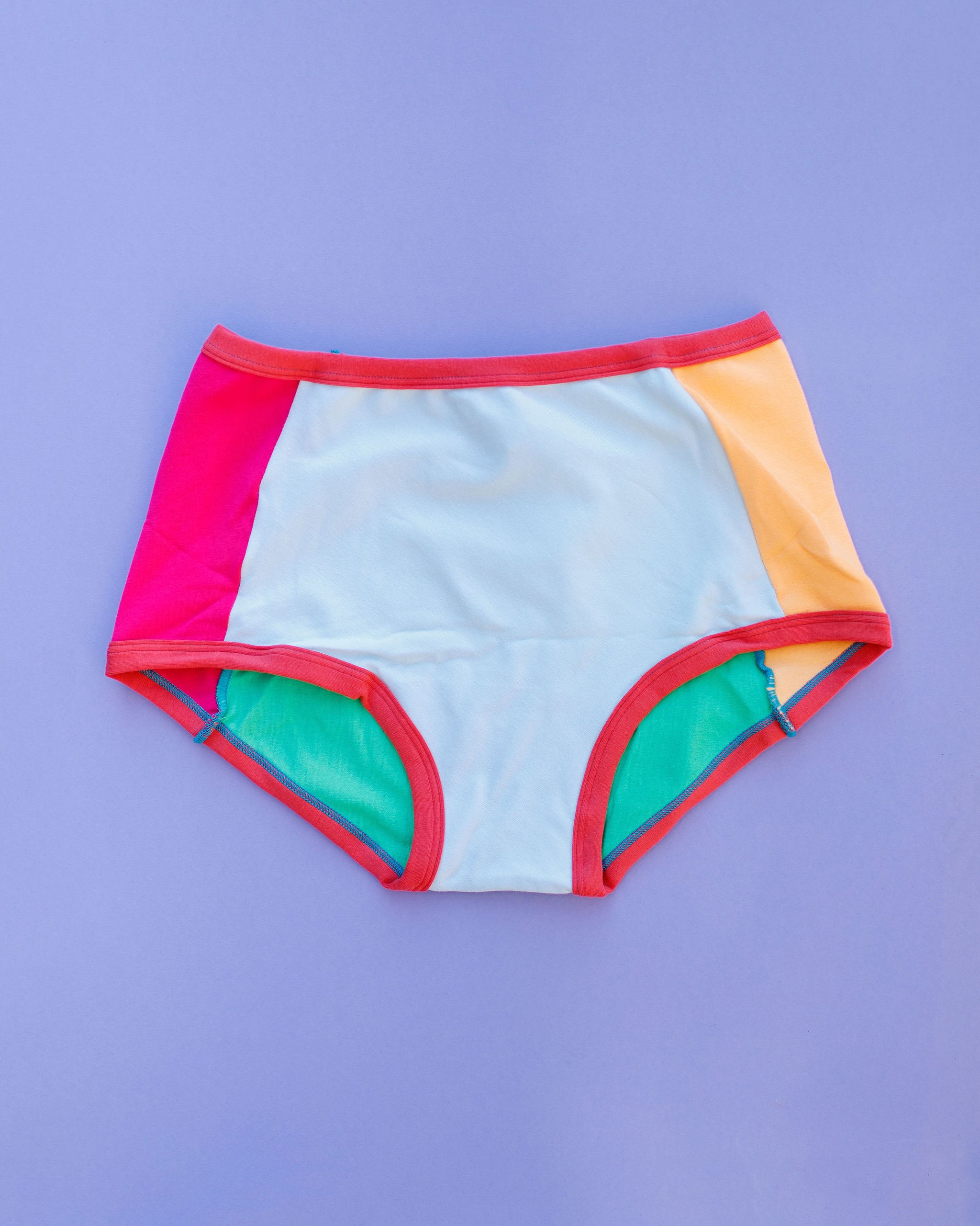 Flat lay of Thunderpants Panel Pants Original style underwear in Color Block Scraps - various solid colors.