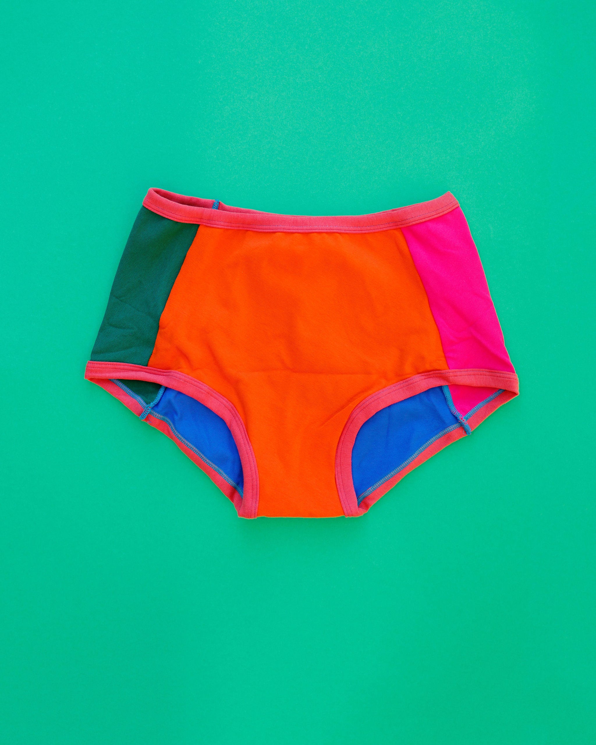 Flat lay of Thunderpants Panel Pants Original style underwear in Color Block Scraps - various solid colors.