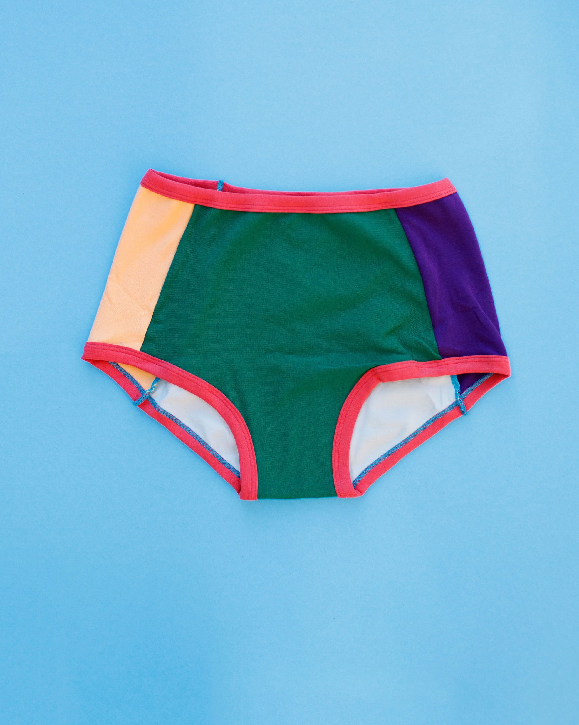 Flat lay of Thunderpants Panel Pants Original style underwear in Color Block Scraps - various solid colors.