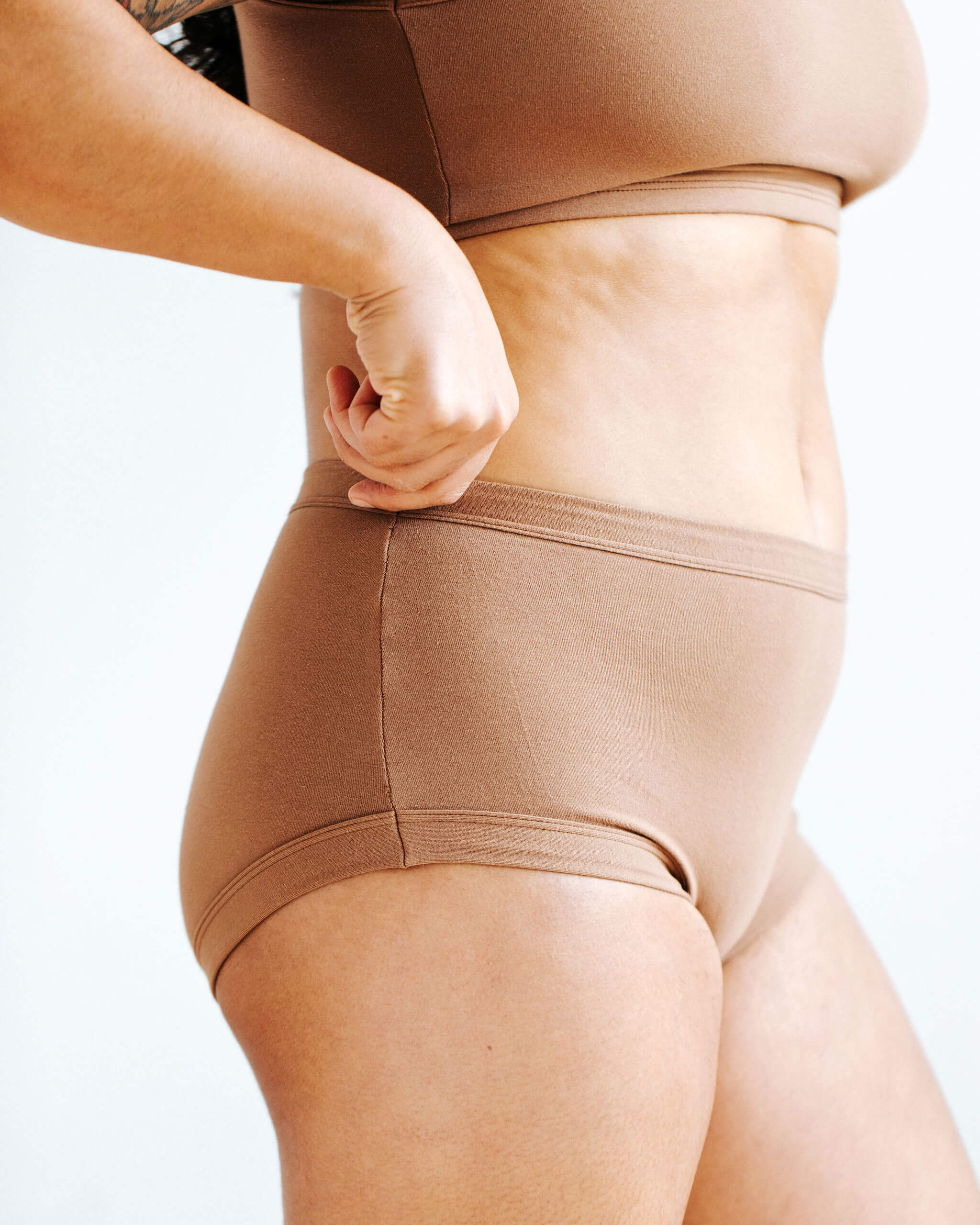 Close up of model wearing Thunderpants Original style underwear in Hazelnut color.