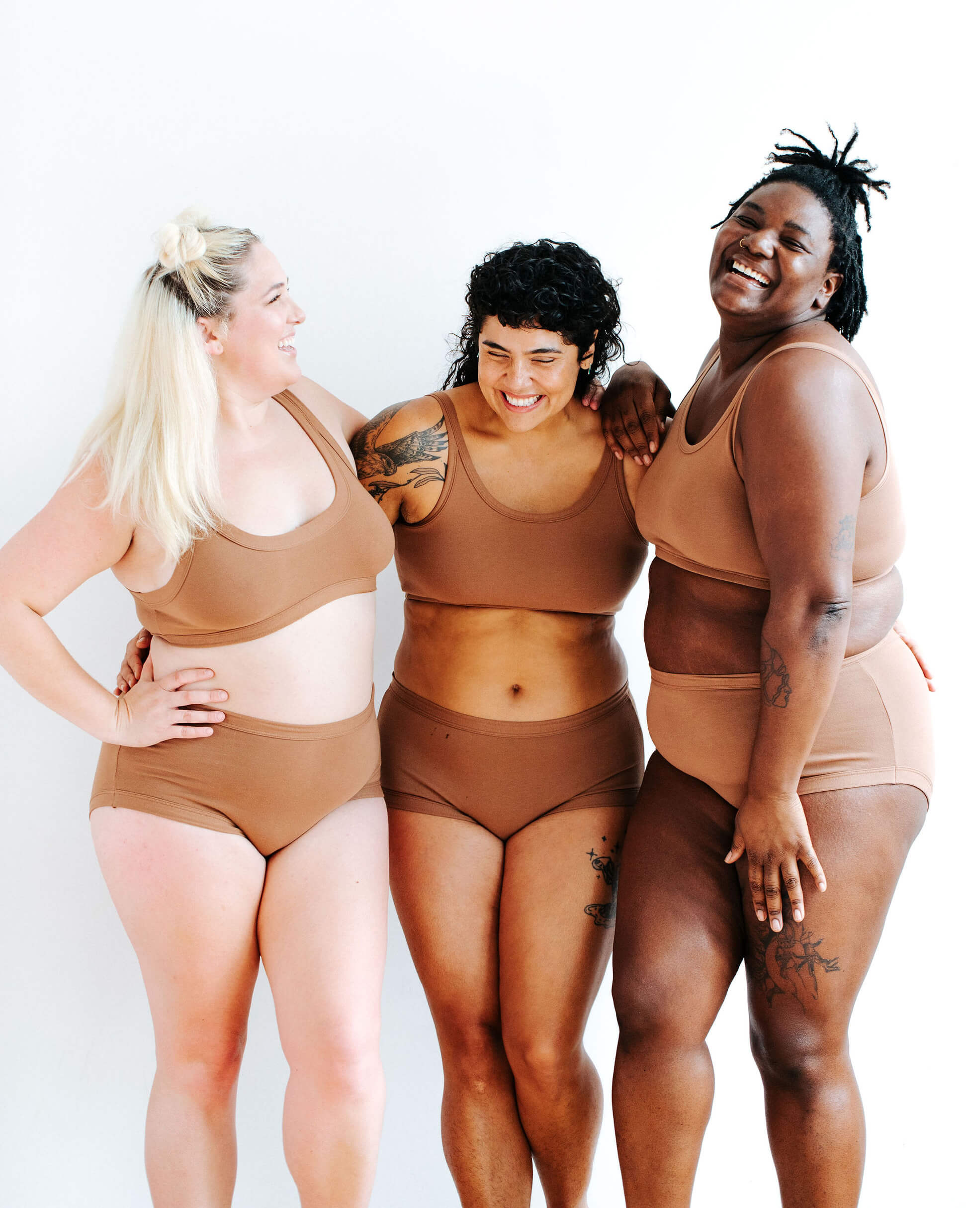 Three models wearing Thunderpants Original style underwear and Longline Bra sets in Hazelnut color.