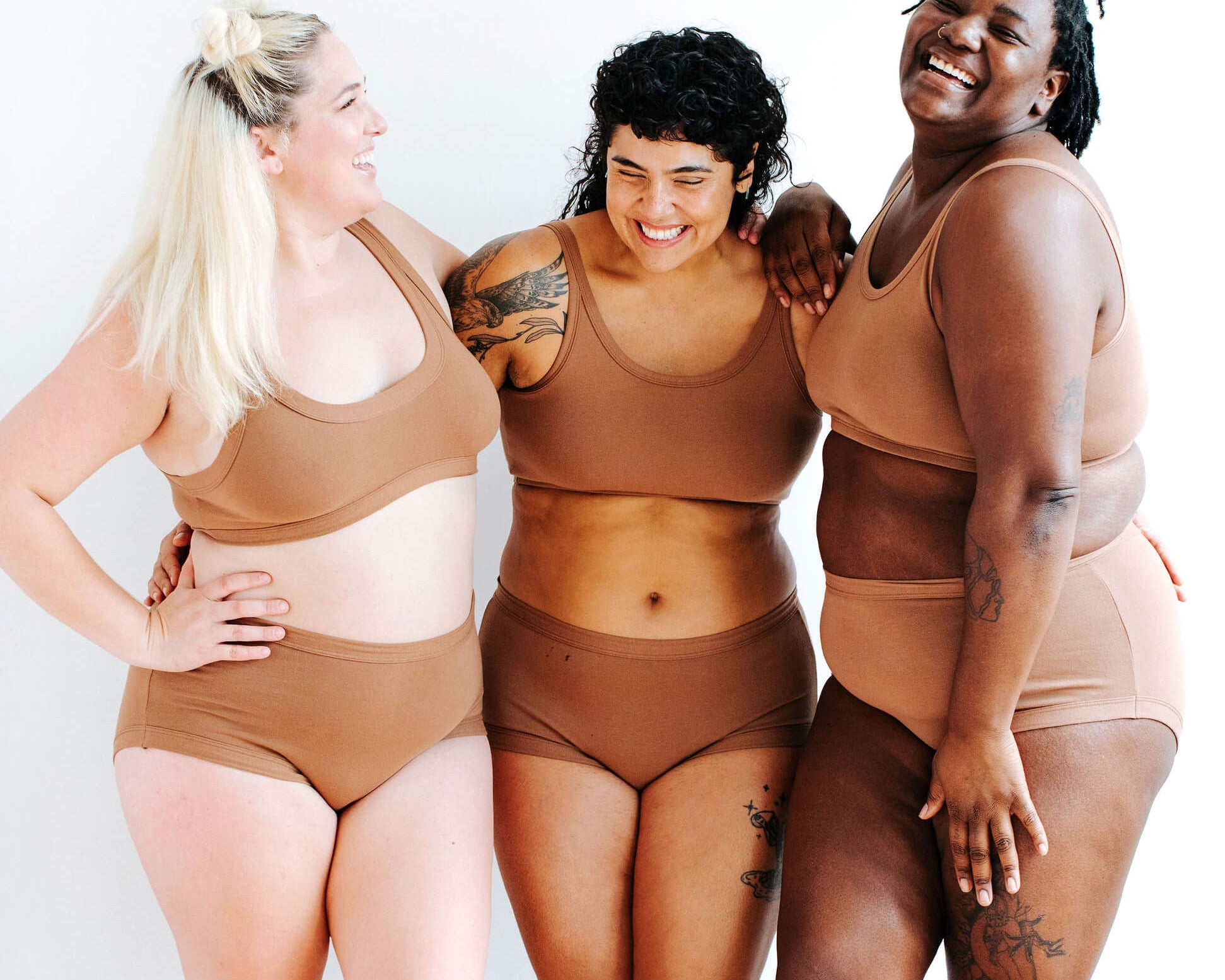 Three models wearing Thunderpants Original style underwear and Longline Bra sets in Hazelnut color.